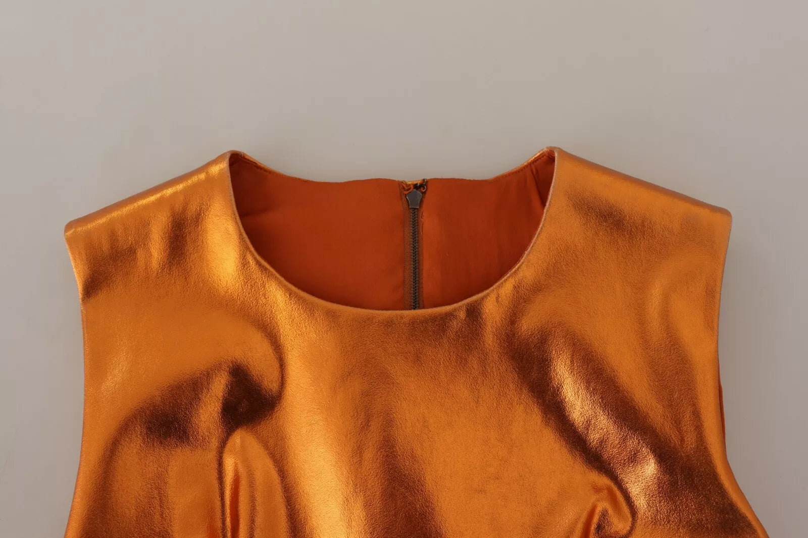 A sleeveless orange dress with metallic texture