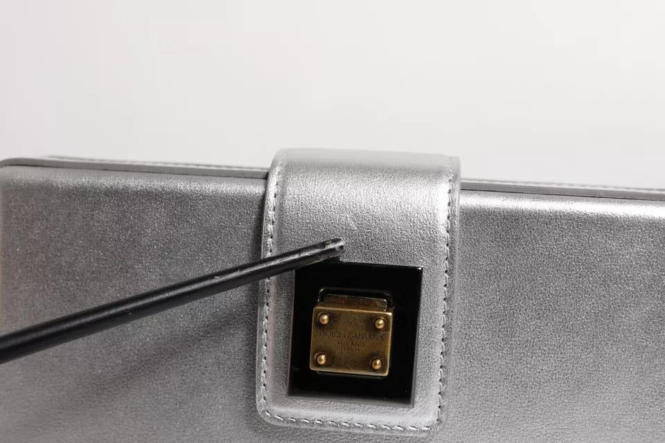 Silver metal box with a gold connector on top