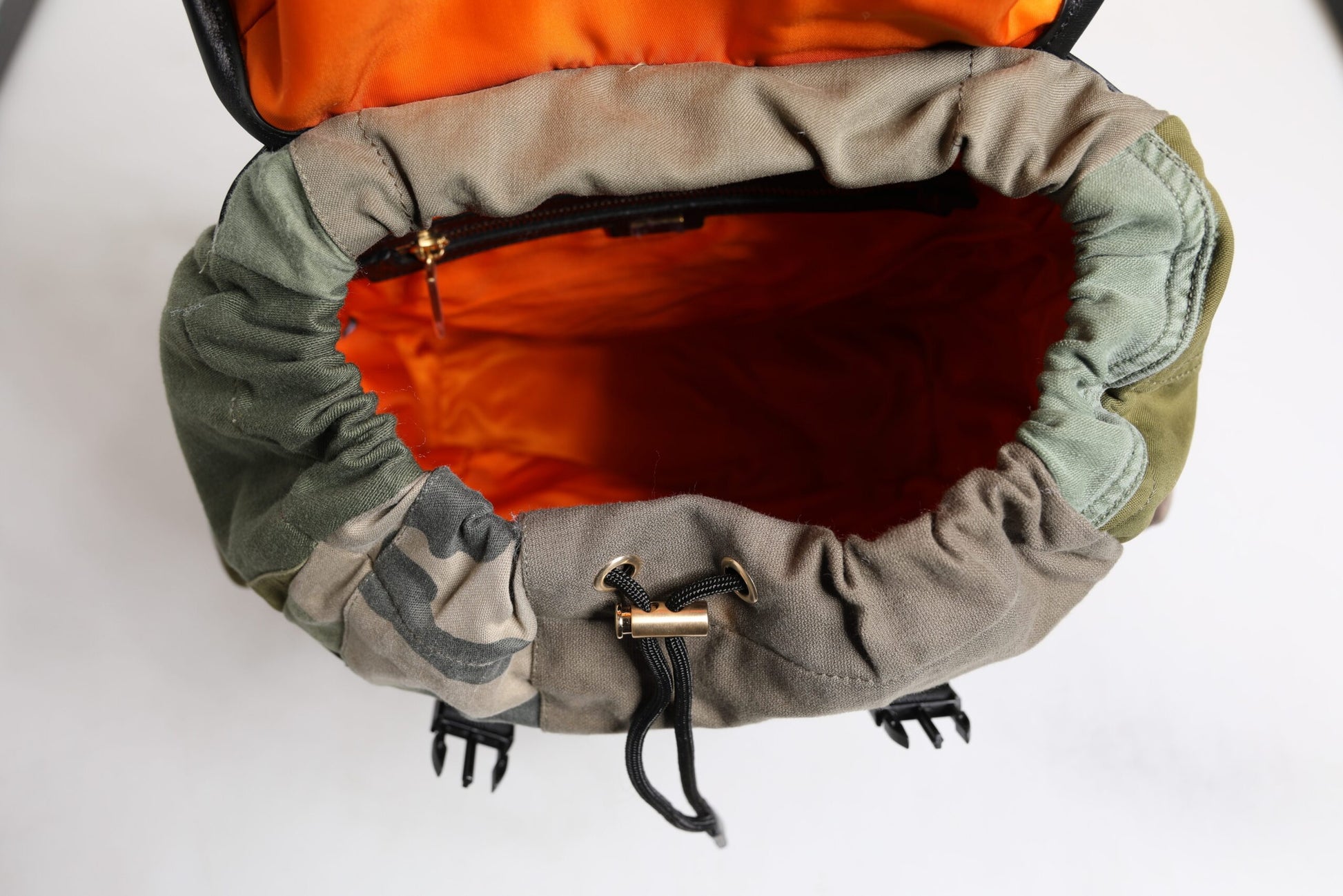 Green and orange backpack with a hood
