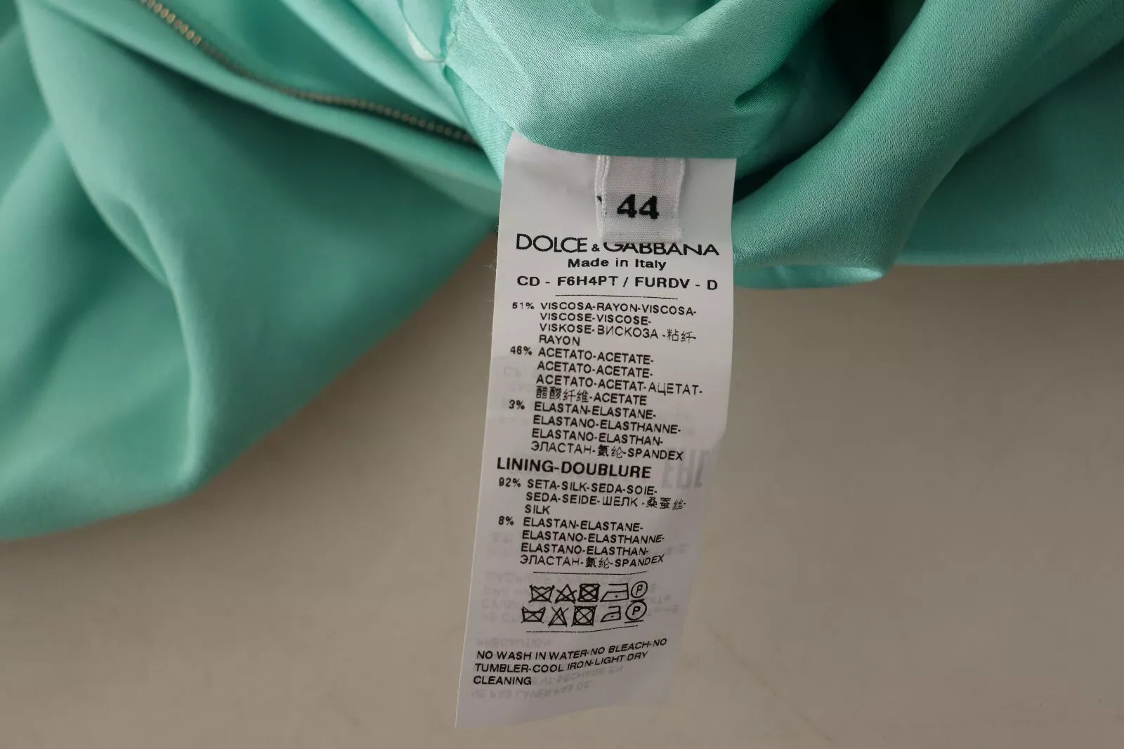 A mint green sheath dress with a square neckline and midi length, from the brand Dolce & Gabbana