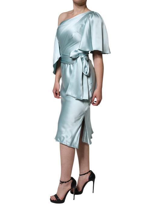 Woman wearing a light blue dress with ruffles on sleeves and waist