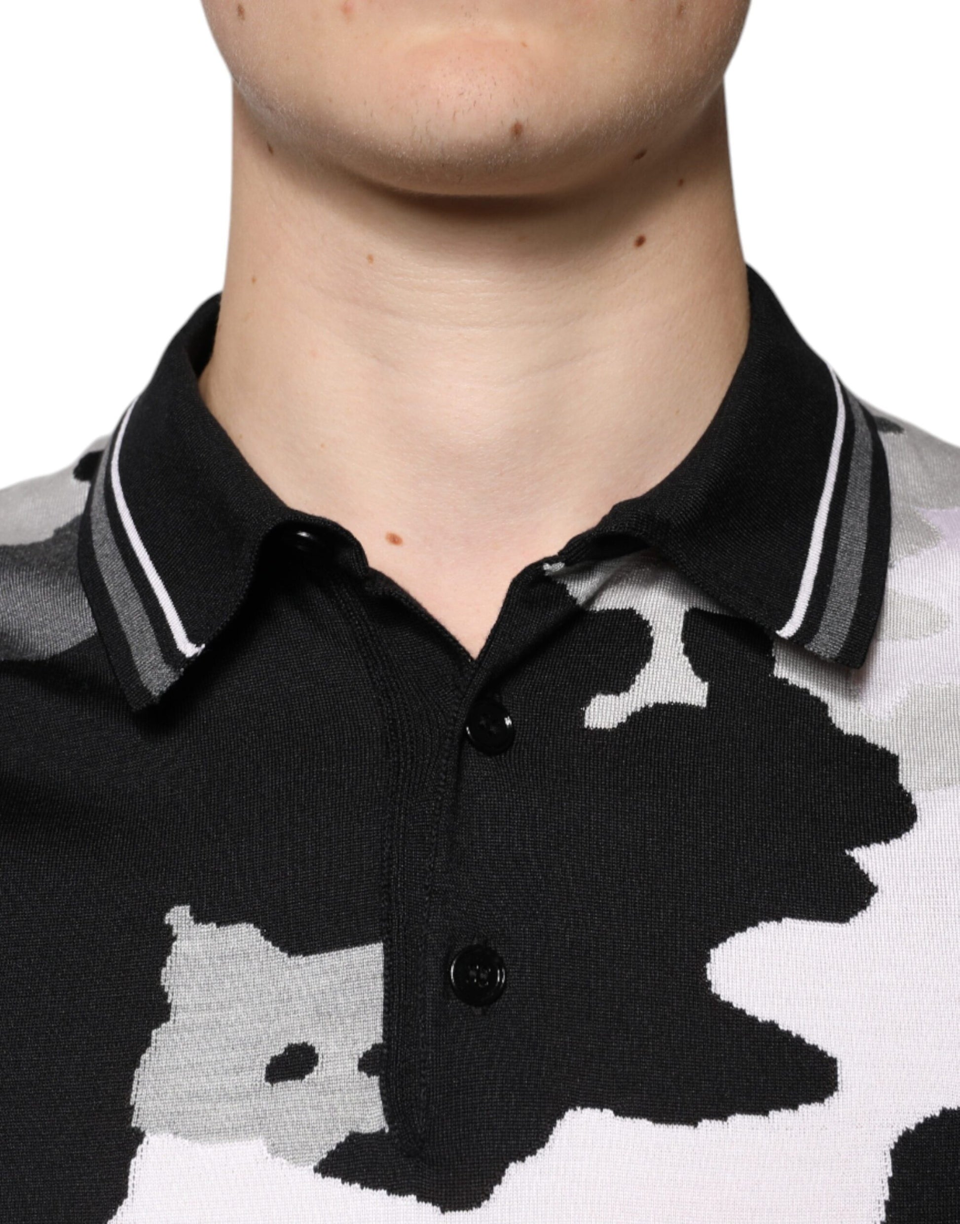 Black and white polo shirt with a cow print pattern on the front