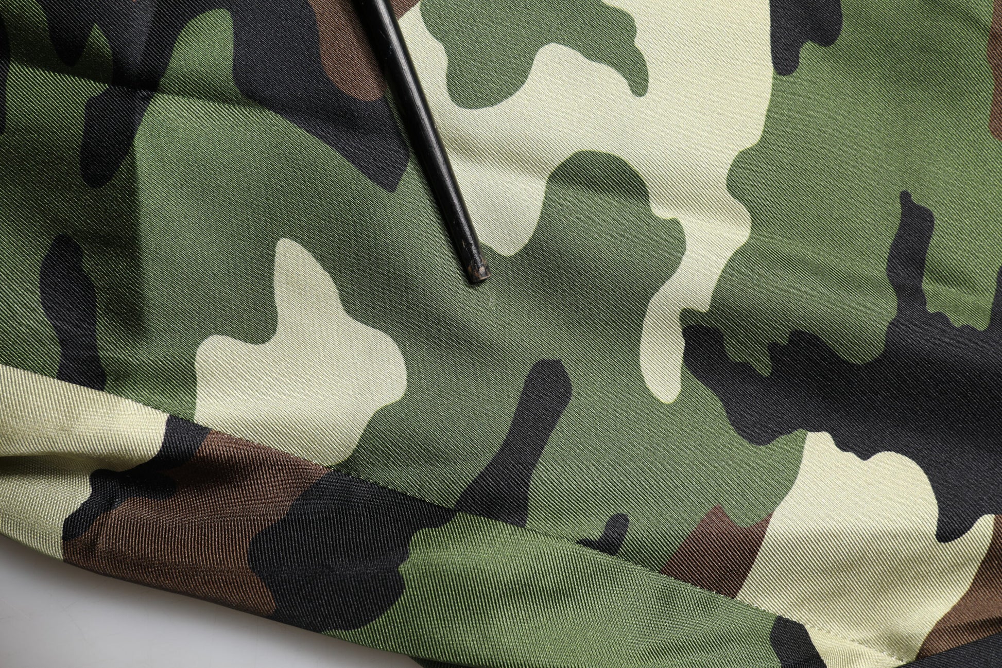 A camouflage patterned pair of shorts with a silky texture