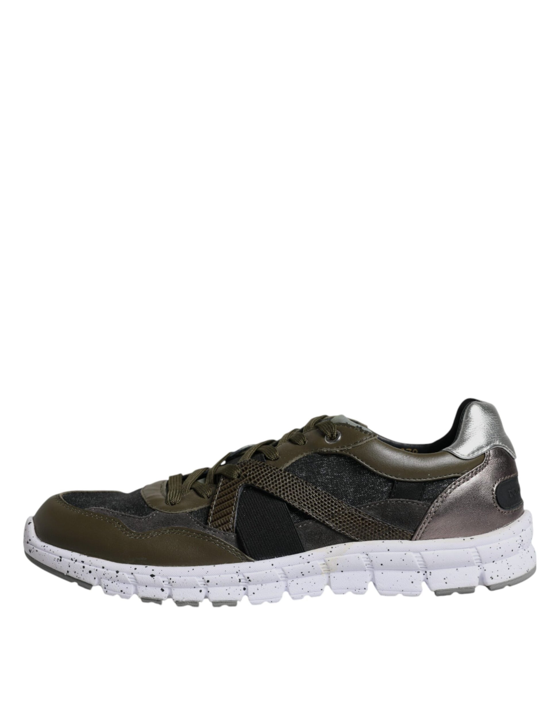 A pair of black, white, and silver sneakers with a canvas texture on the upper