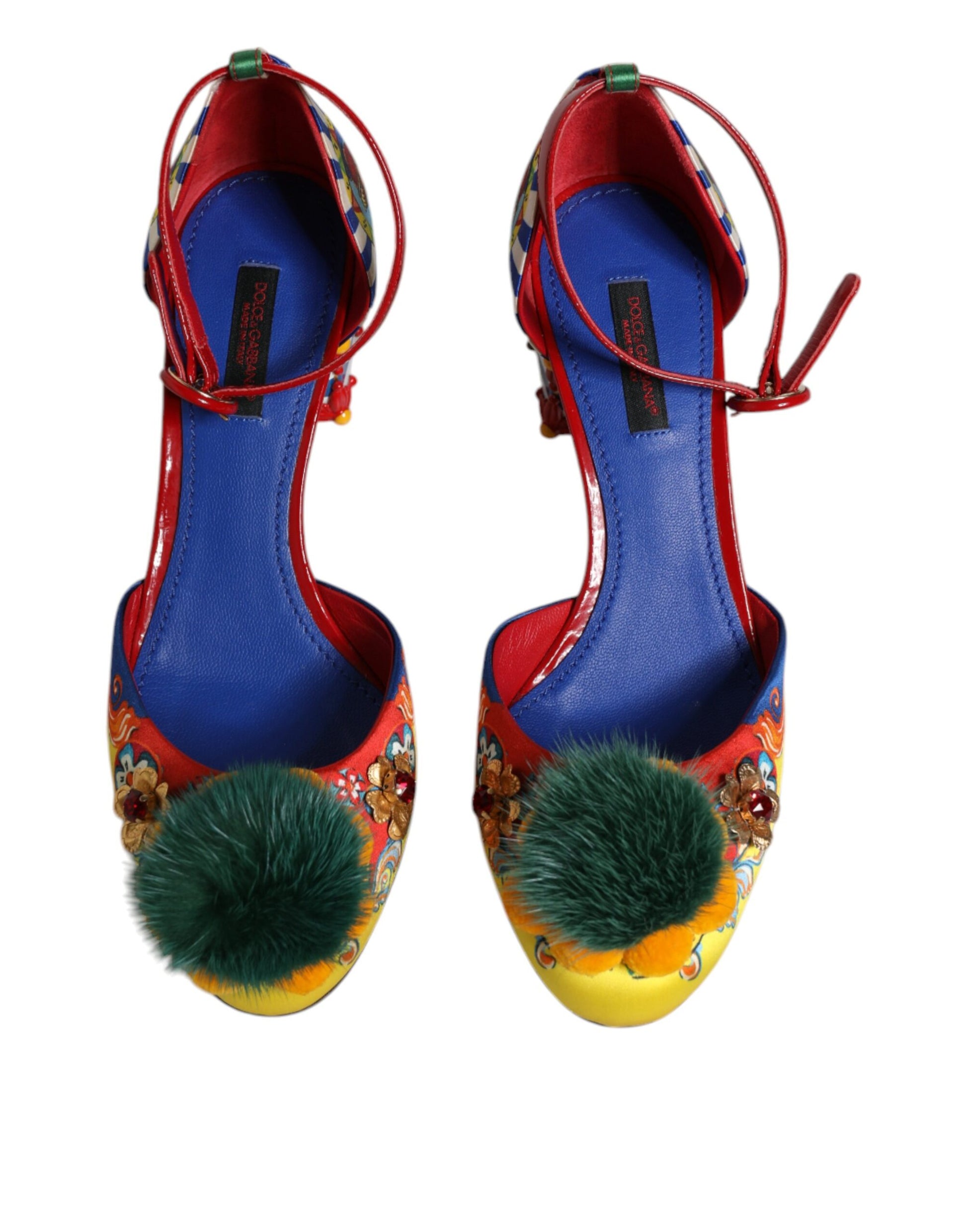 Pair of colorful women's shoes with red laces and fluffy pom poms on heels