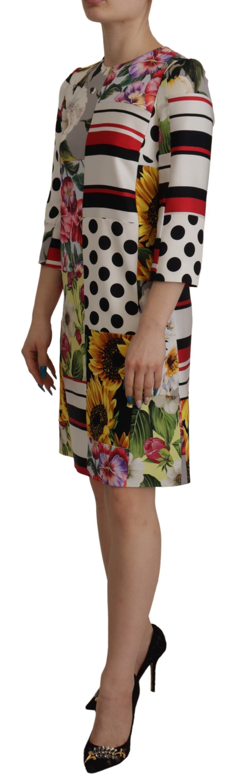 A woman wearing a colorful floral dress with short sleeves and a pencil skirt