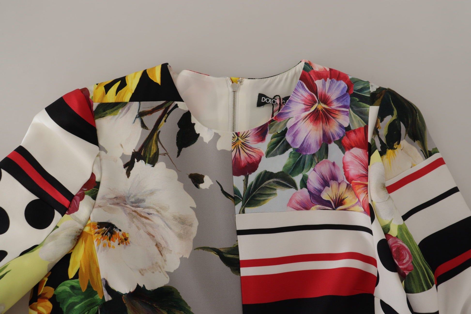 A colorful floral patterned dress with a sheath silhouette