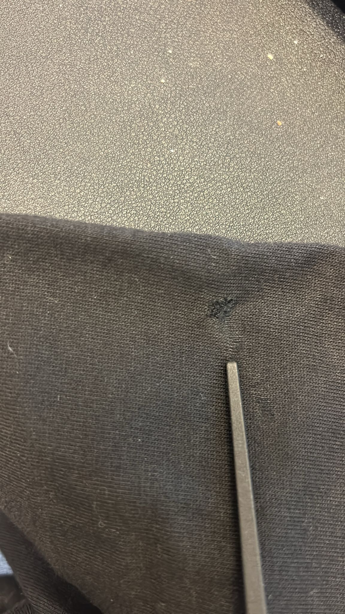 Black fabric with a hole in it
