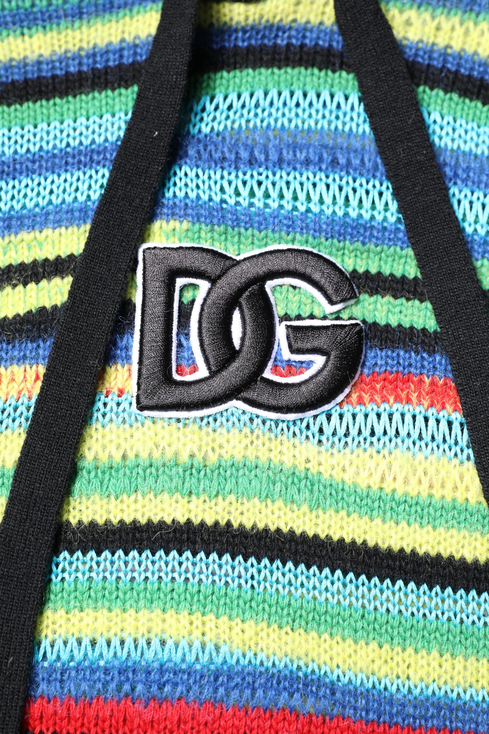 Colorful striped fabric with a black logo on it