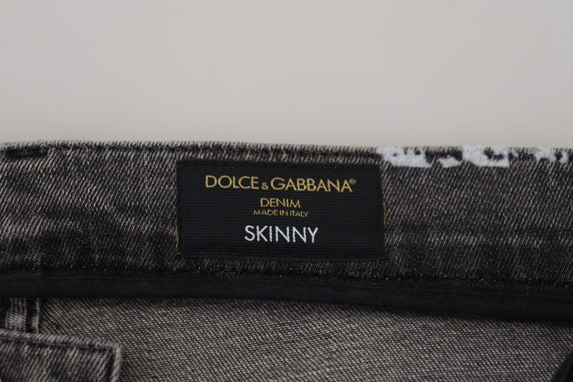 Black label on fabric reading "D&G Dolce & Gabbana Slim