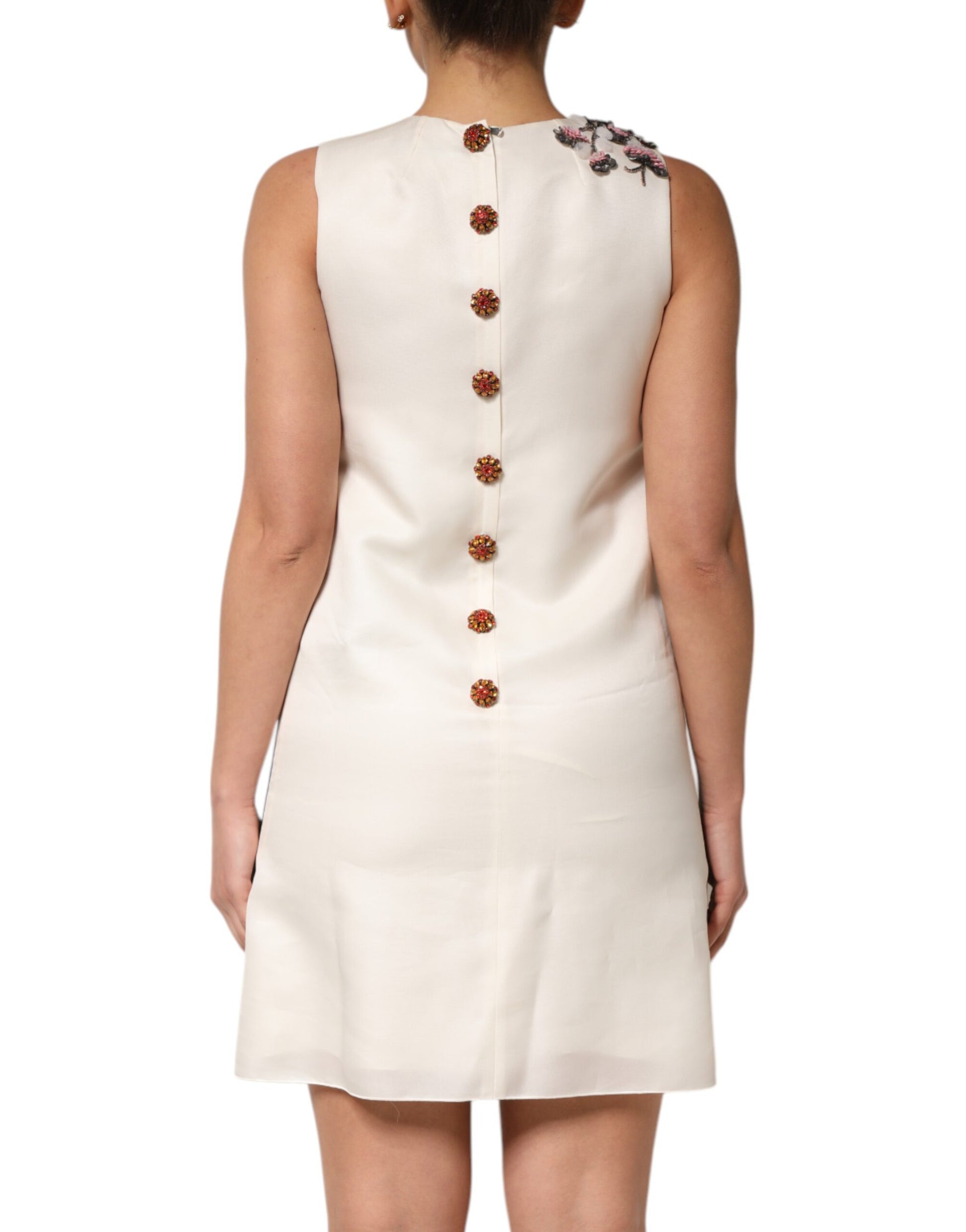 White dress with multicolored crystal embellishments on back and sleeves