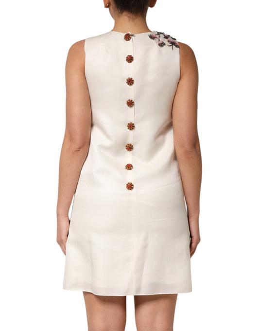 White dress with multicolored crystal embellishments on back and sleeves