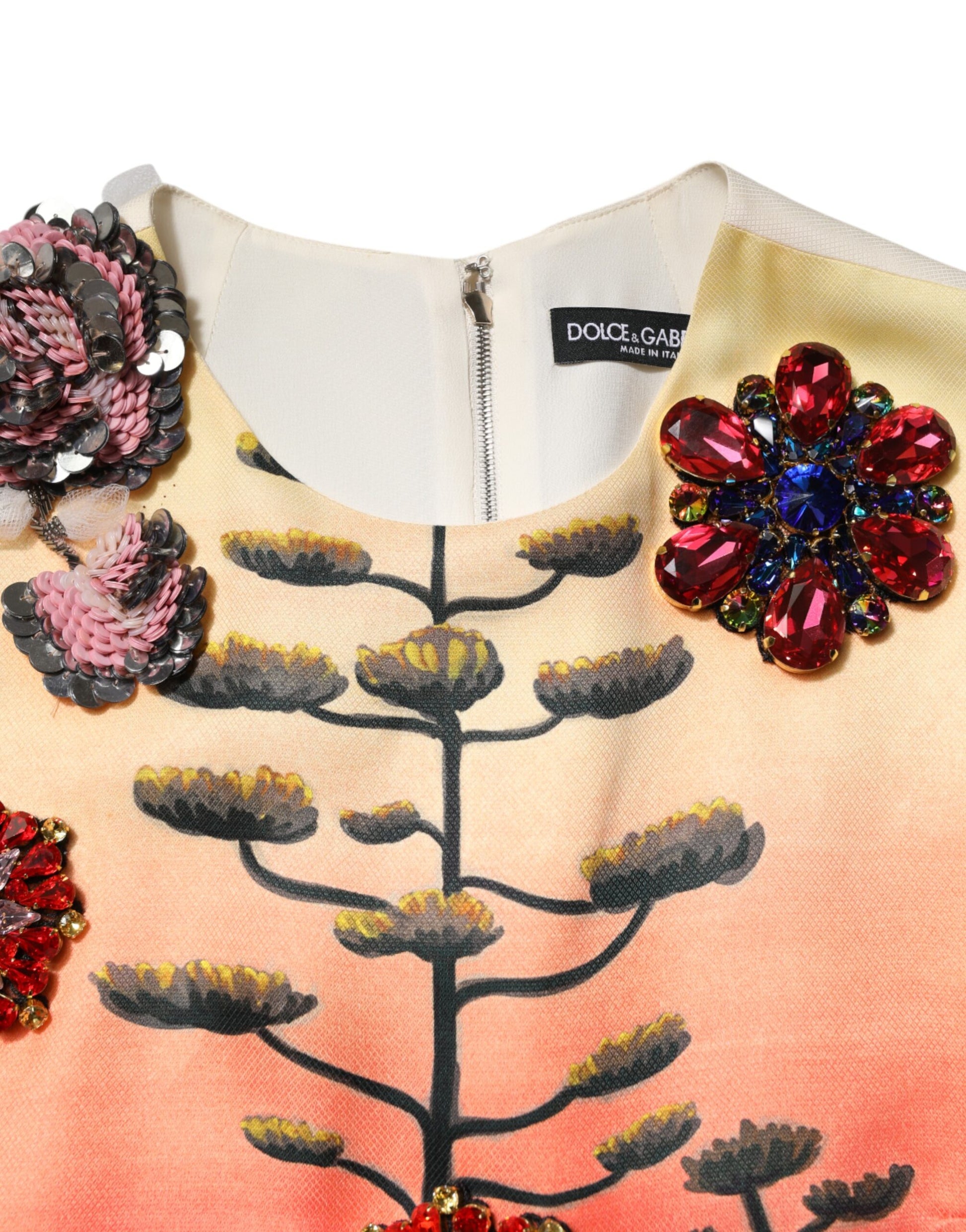 A colorful dress with crystal embellishments and a floral pattern