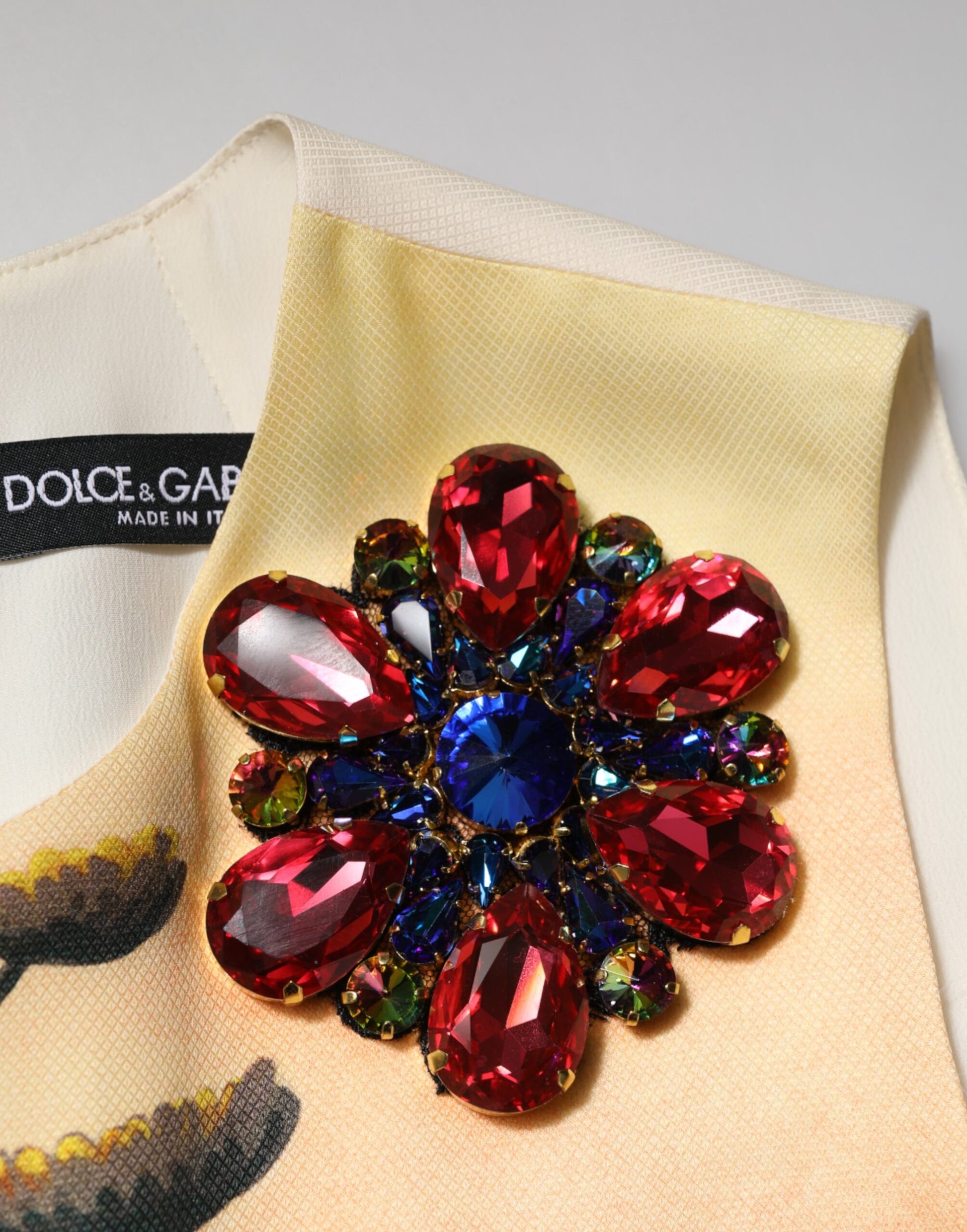 A multicolored crystal embellished dress from the brand Dolce & Gabbana. It is an A-line mini dress with a pr