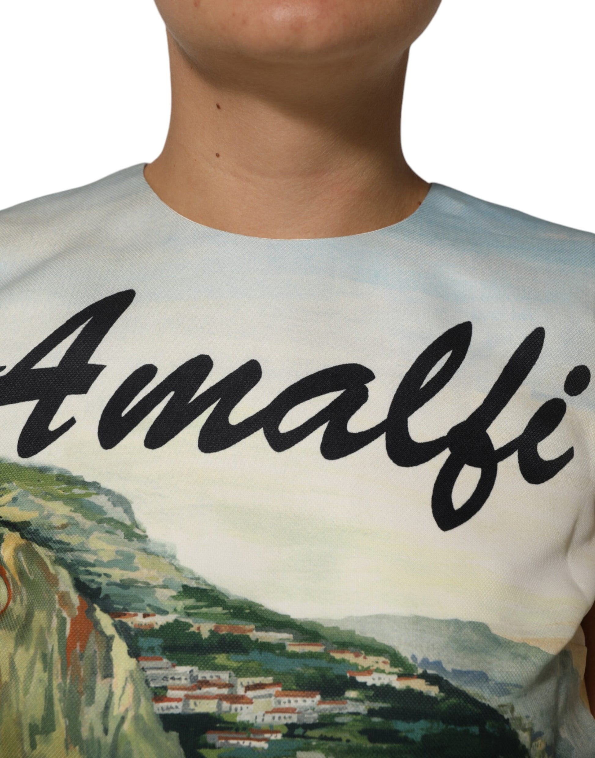 A multicolored dress with crystal embellishments, featuring a landscape print on the front