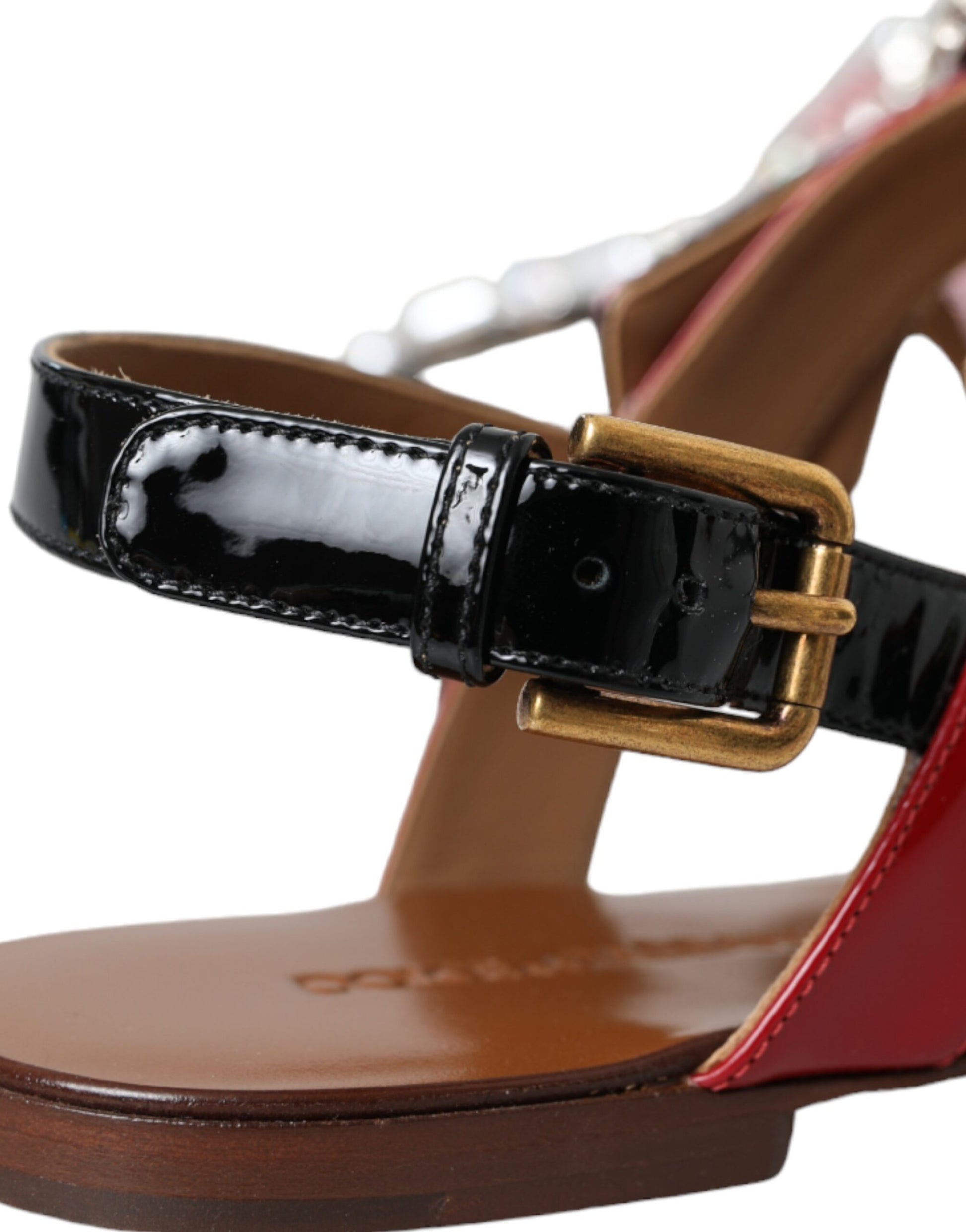 Brown sandal with black strap and gold buckle