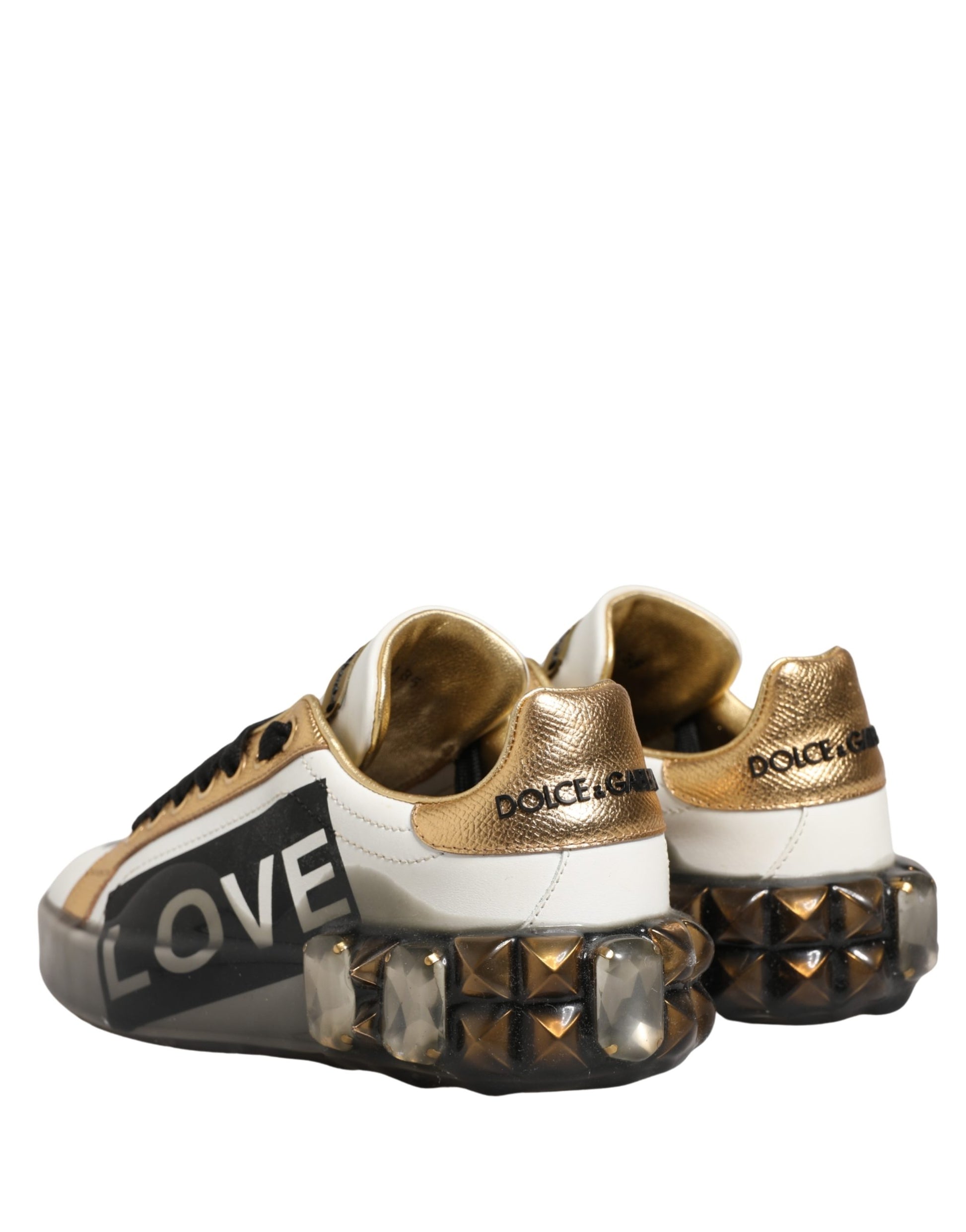 Gold and white sneakers with crystals, featuring the word "LOVE" in black text