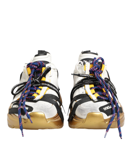 Pair of multicolored sneakers with gold accents, laces and soles