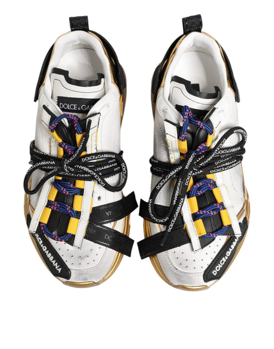 Pair of white sneakers with yellow laces and black straps