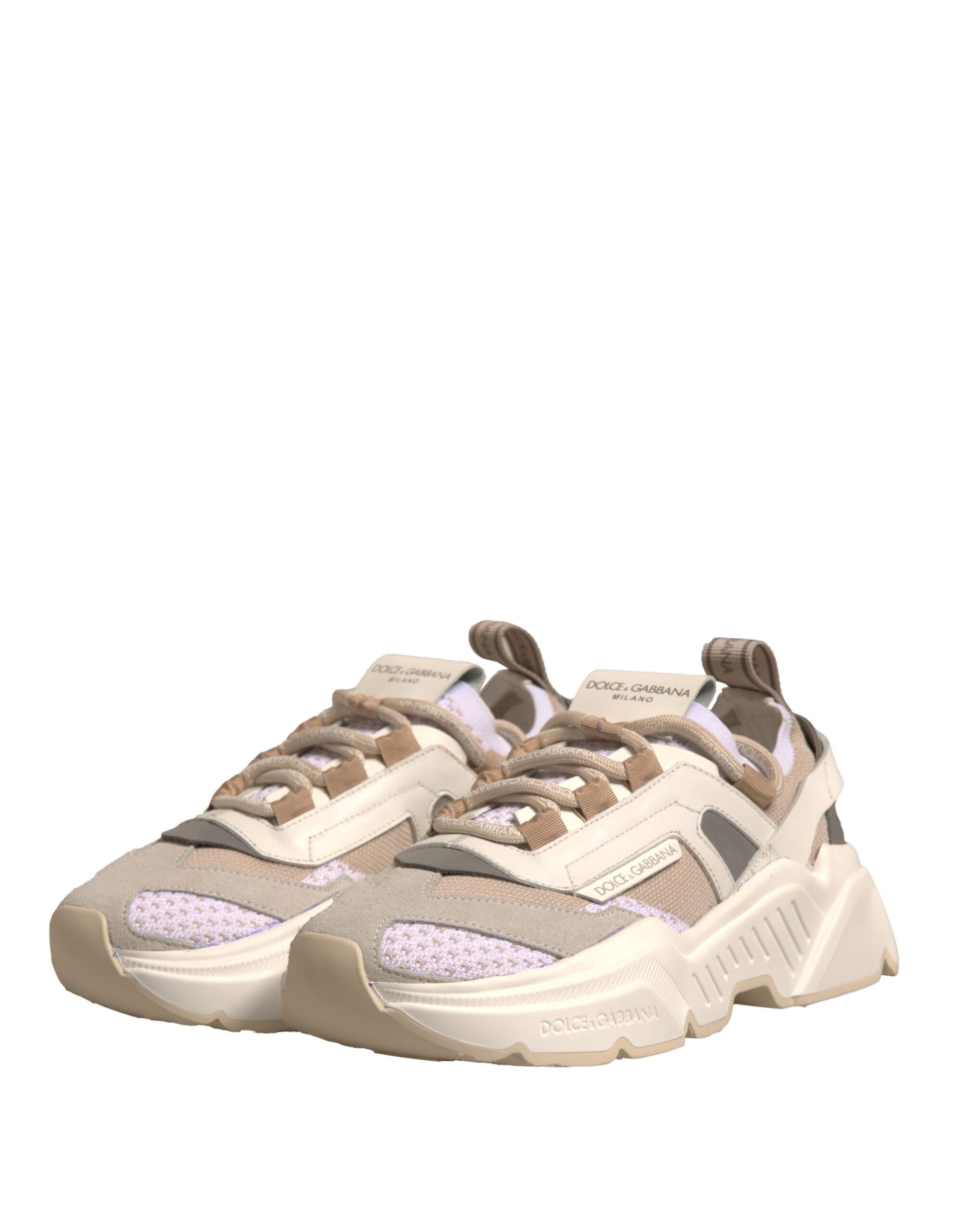 Tan sneakers with white laces and a pink logo on the side