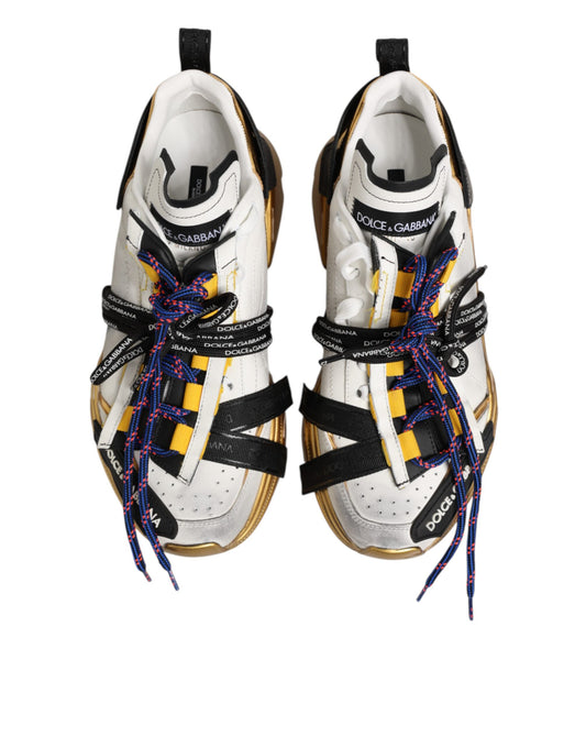 Pair of multicolored sneakers with laces and a bow on top, featuring the brand name