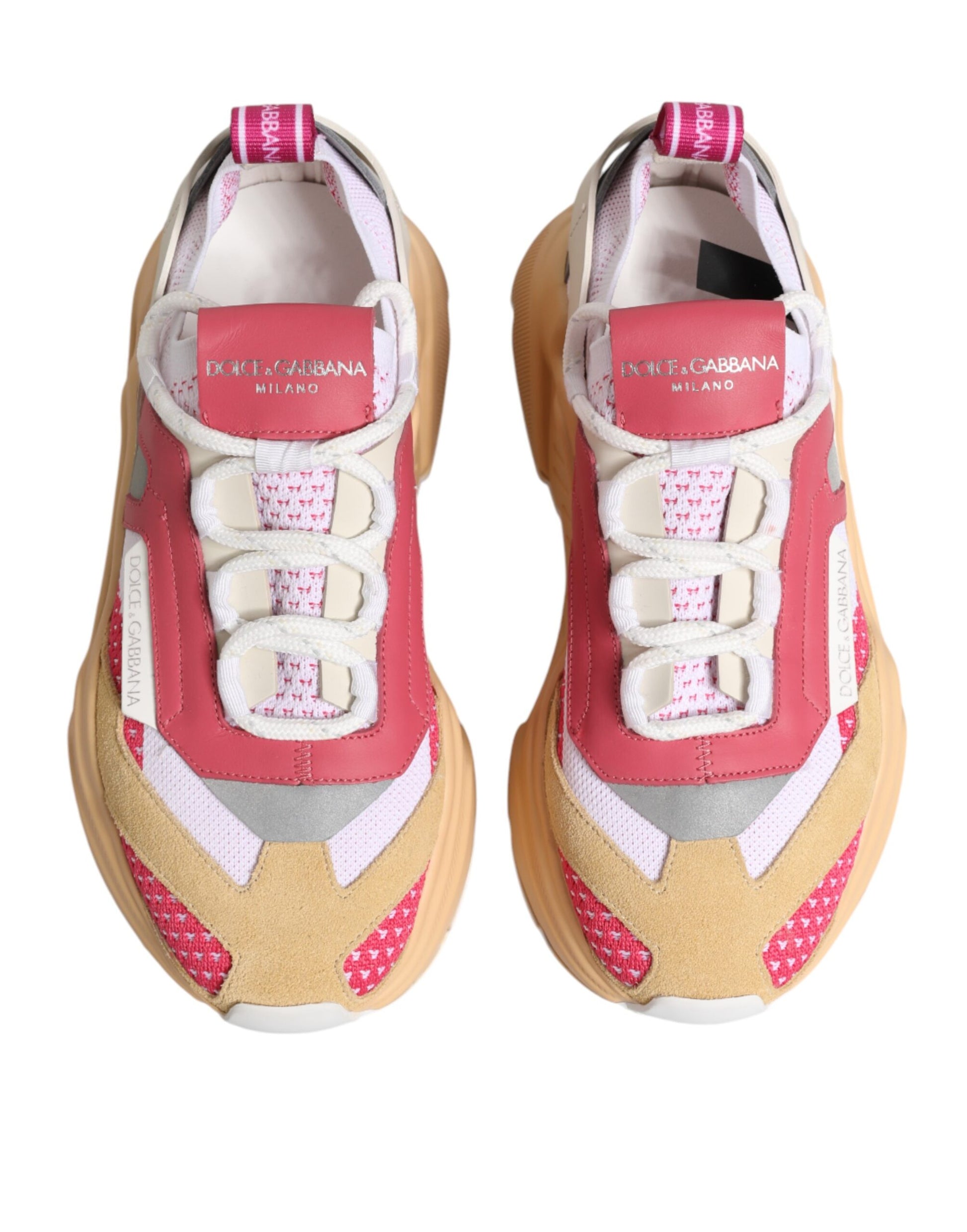 Pair of sneakers with red laces and pink accents