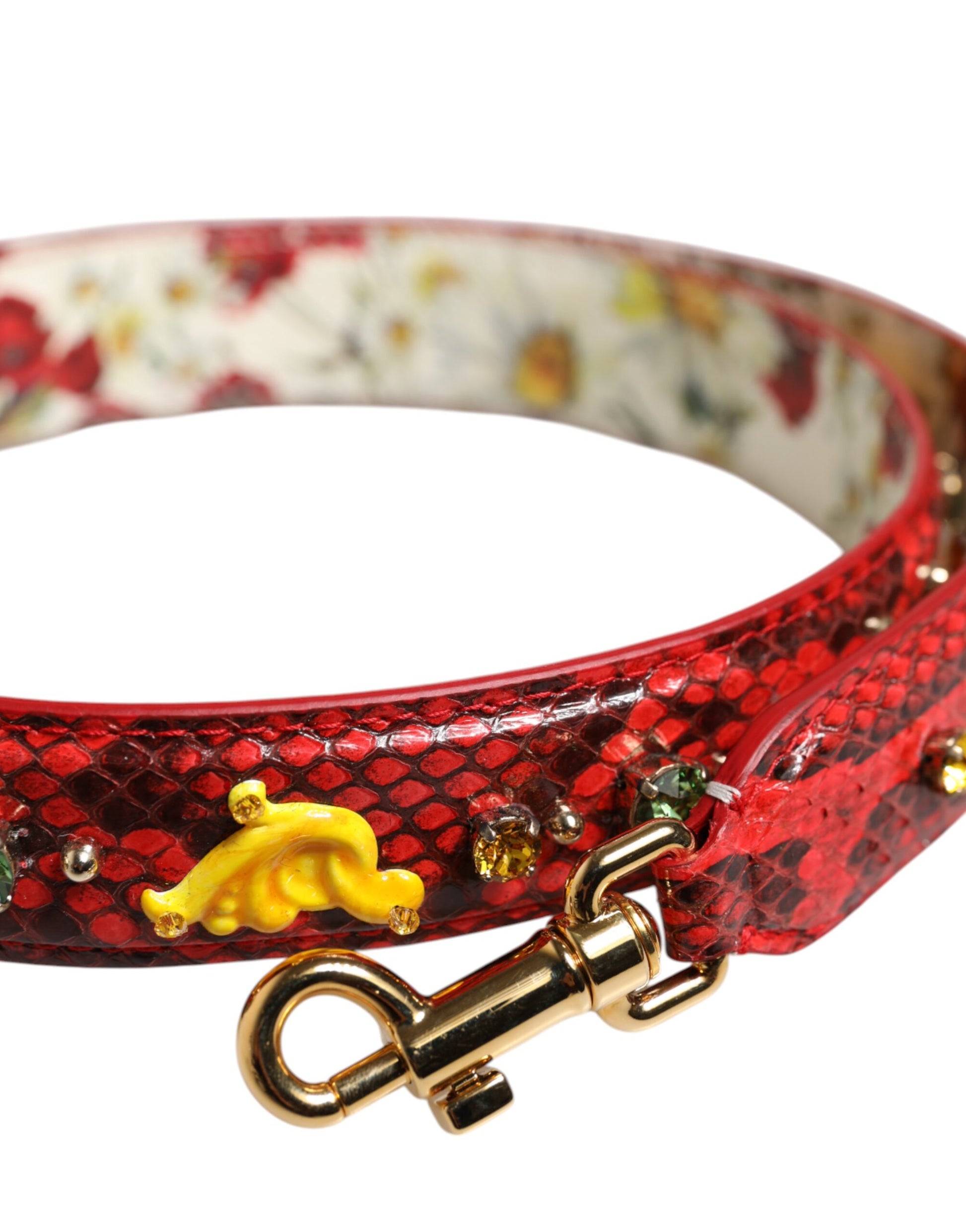 Red snake skin dog collar with gold accents and a yellow fish charm