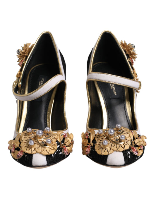 Pair of black high heel shoes with gold accents and pearl embellishments