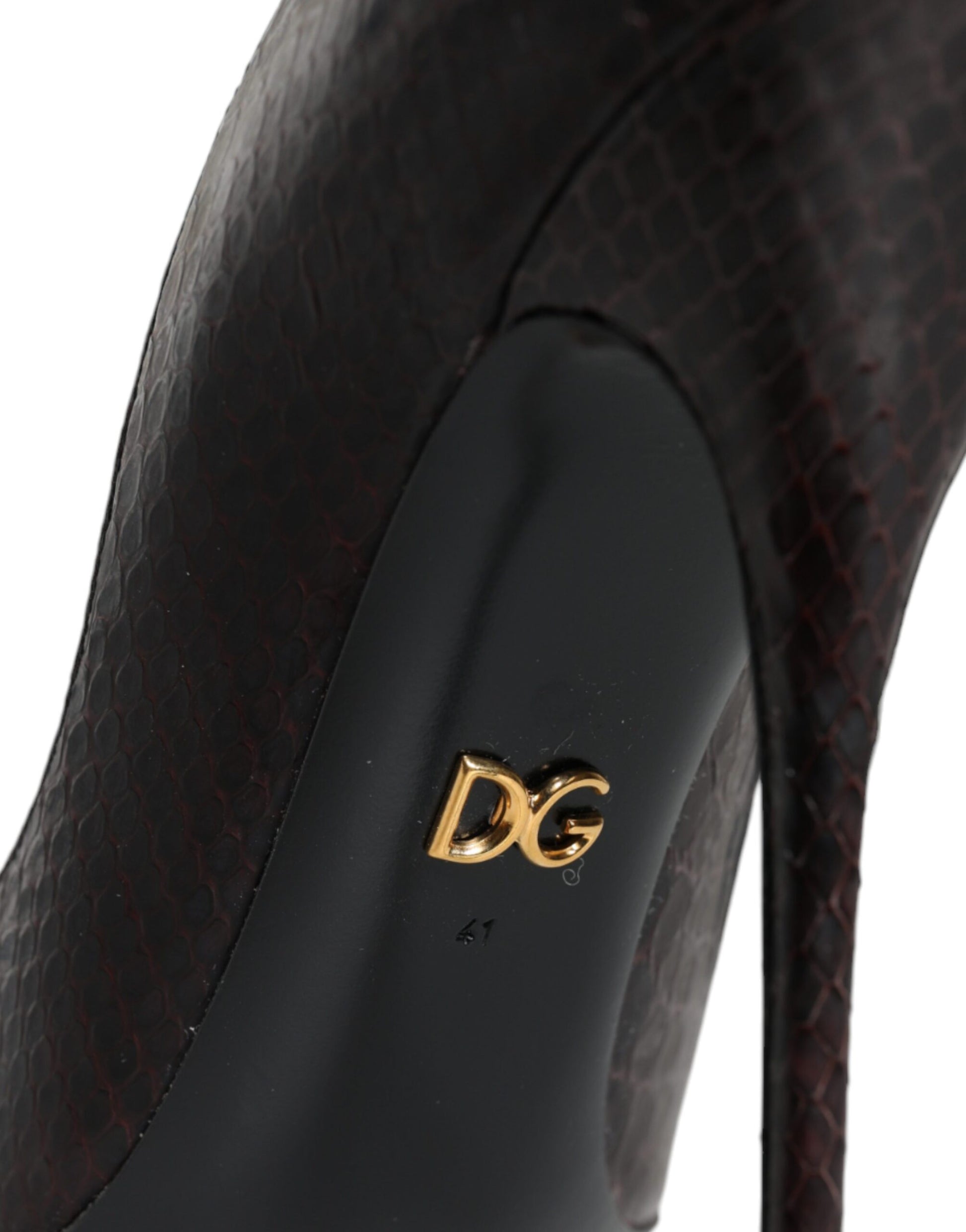 High heel shoe with a gold logo on the side