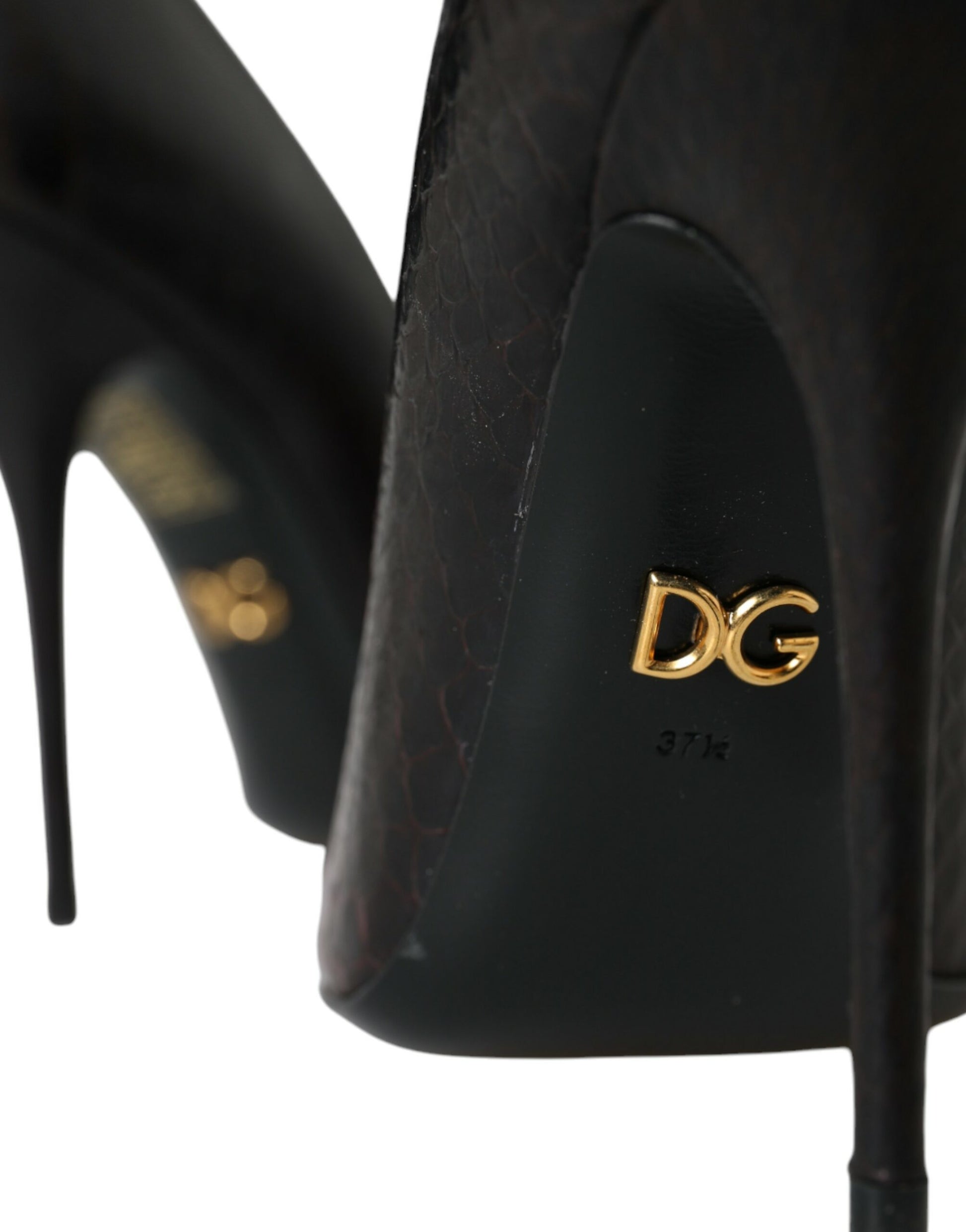 Pair of black high heel shoes with gold lettering on back