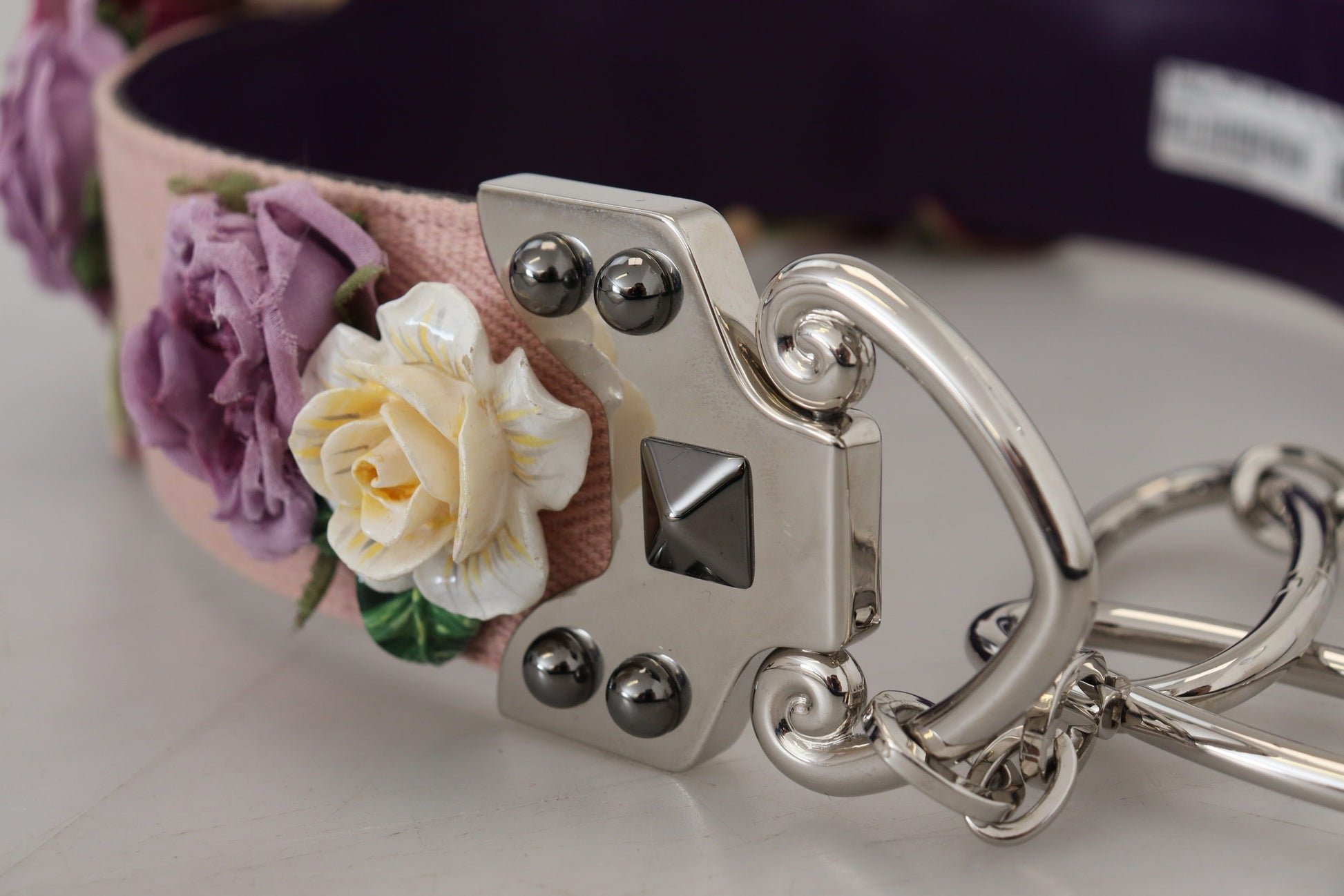 Silver buckle on a pink floral belt
