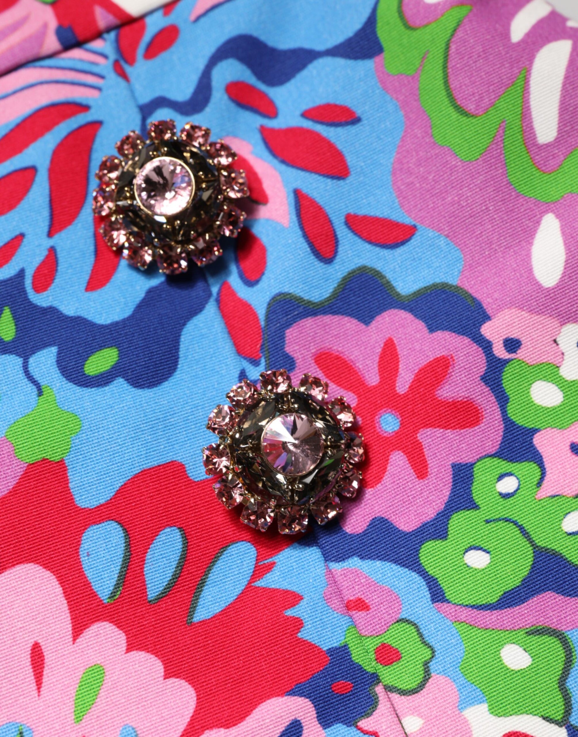 Two pink jewels on a floral shirt