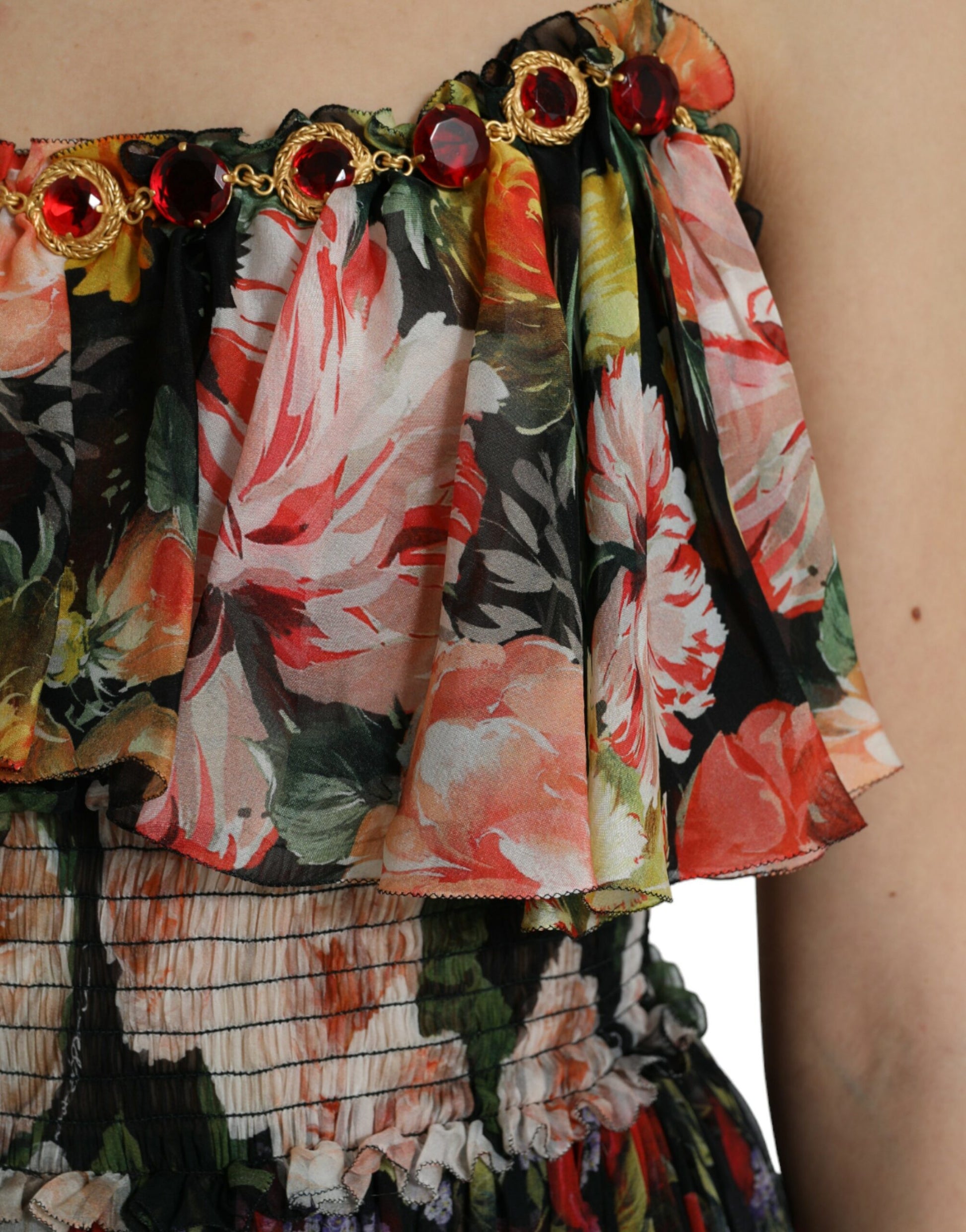 A colorful floral chiffon dress with tiered ruffles and a beaded neckline