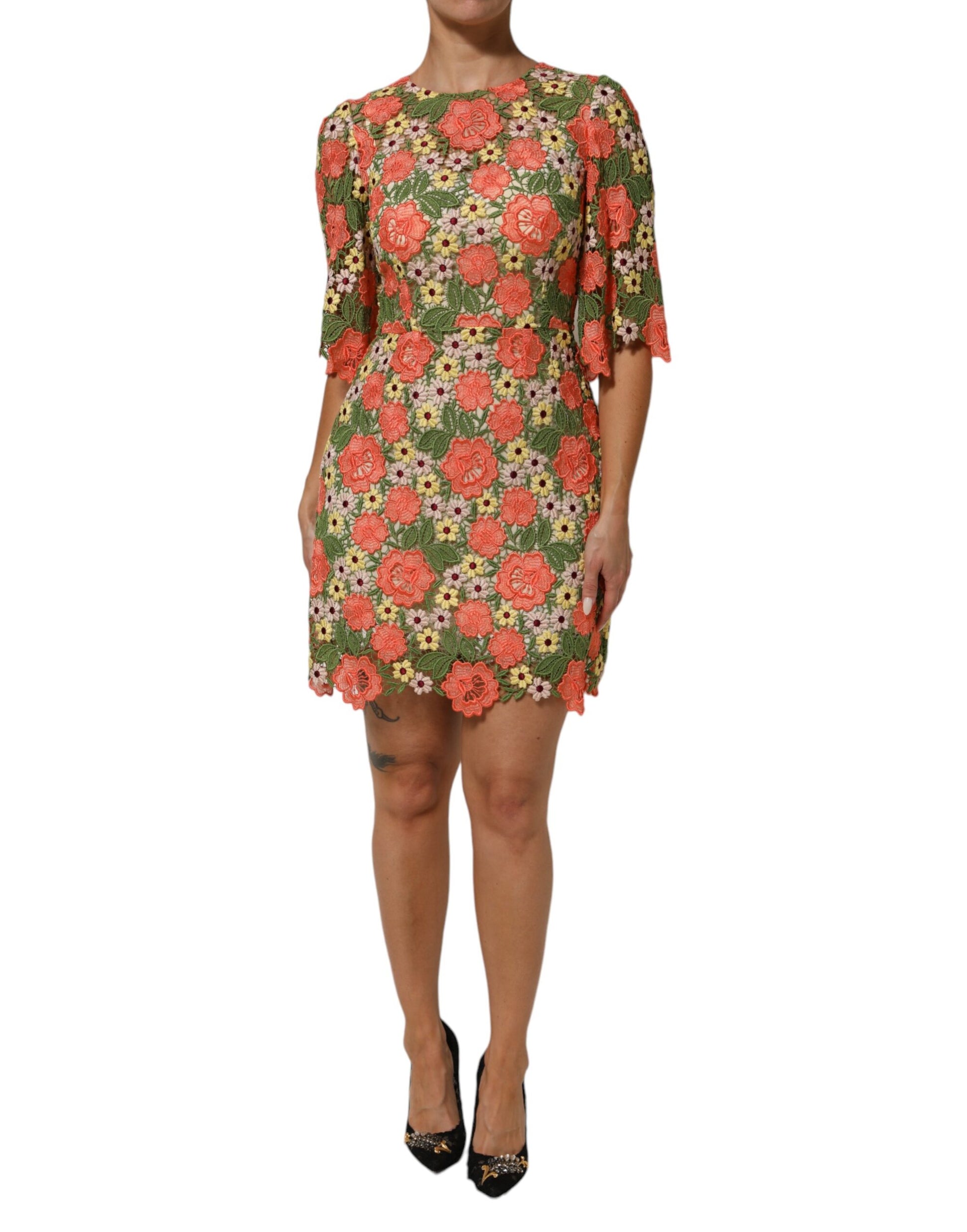 A woman wearing a floral embroidered aline mini dress by Dolce & Gabbana