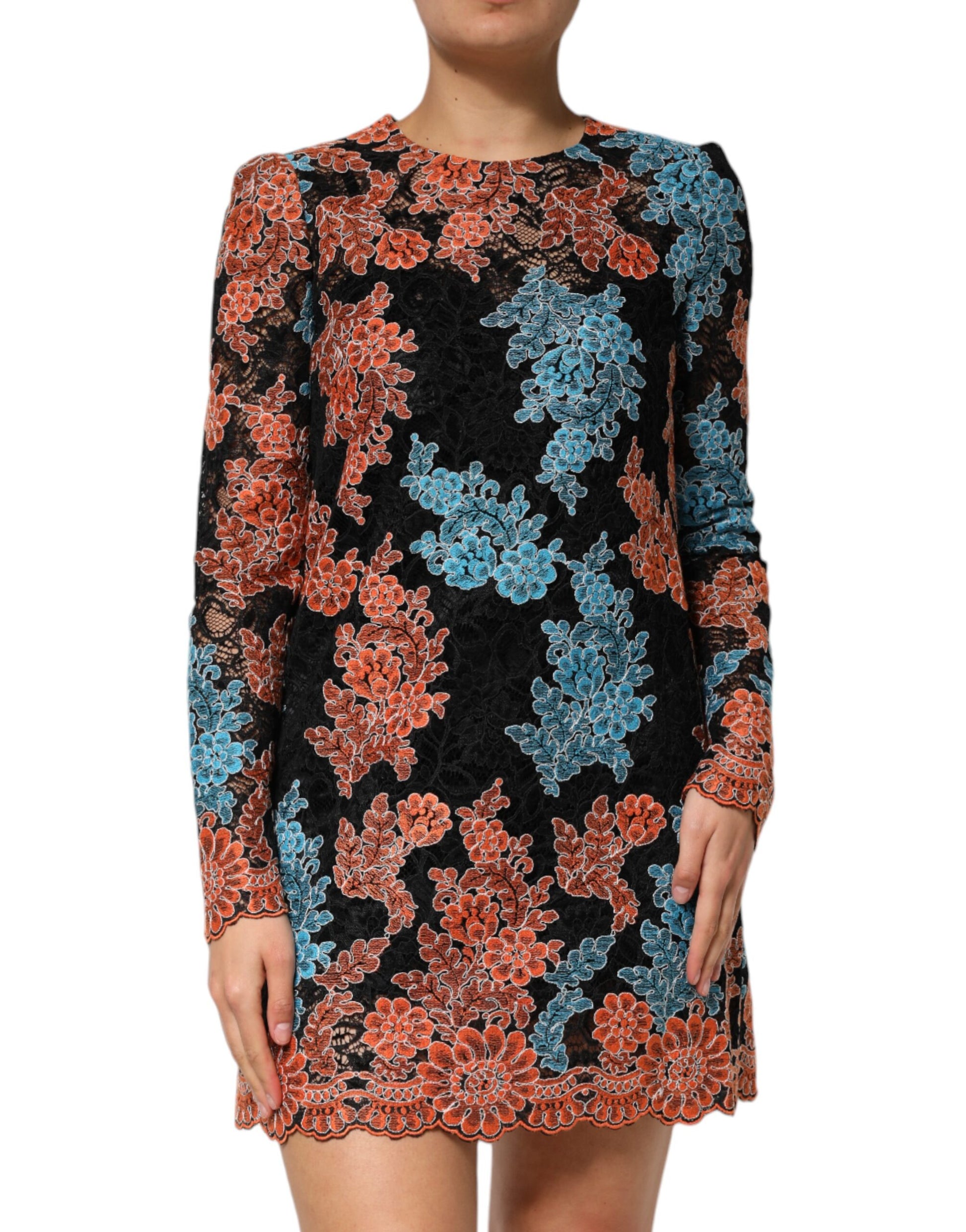 A woman wearing a black, blue and orange floral embroidered shift dress