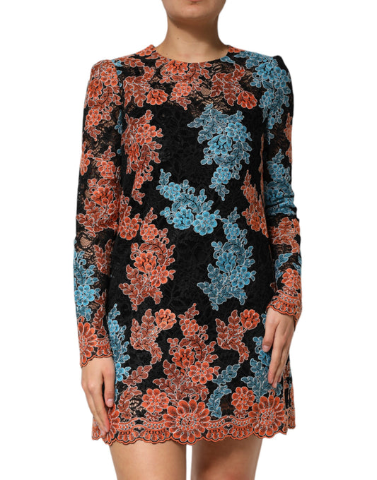 A woman wearing a black, blue and orange floral embroidered shift dress