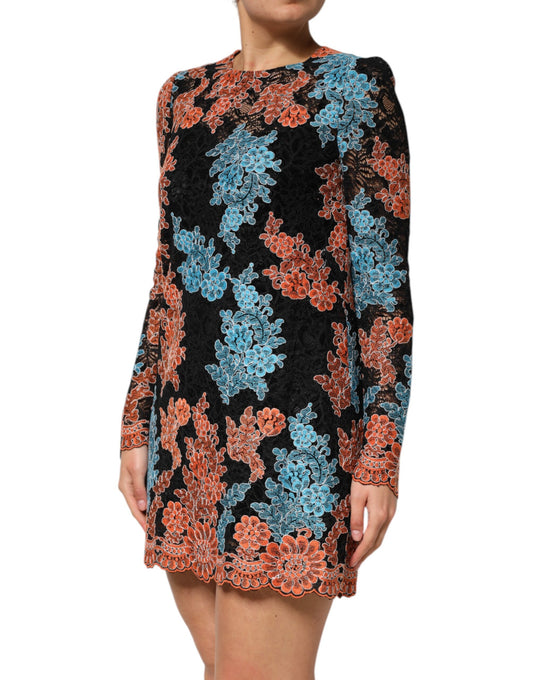 A woman wearing a multicolored floral embroidered shift dress with short sleeves