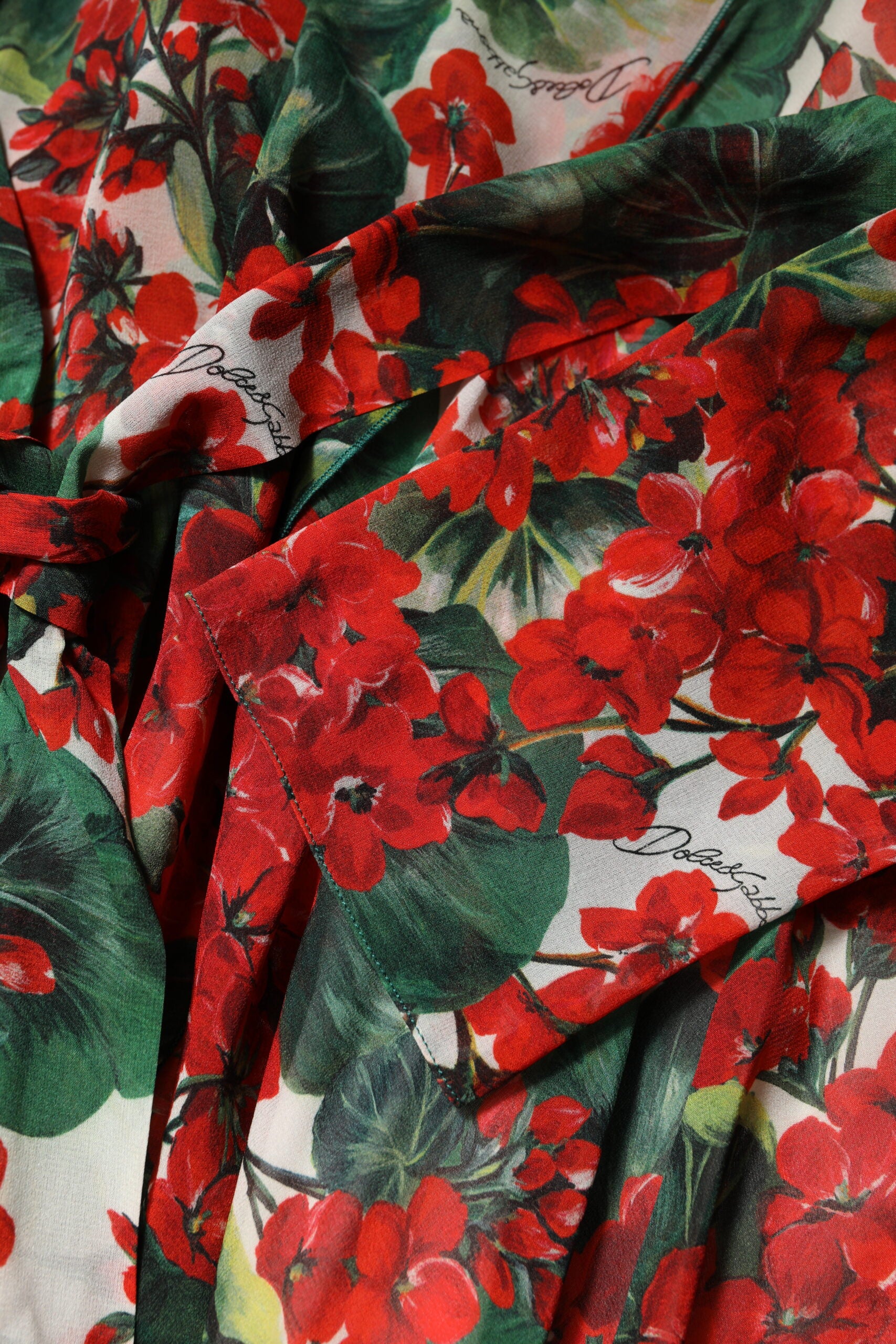 A multicolored floral dress with long sleeves and a V-neck