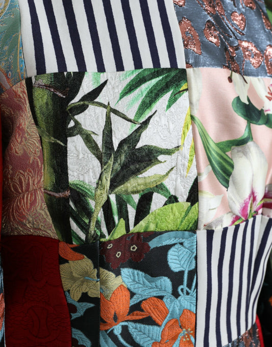 A colorful floral patchwork dress with a shift silhouette, featuring a mix of patterns and textures