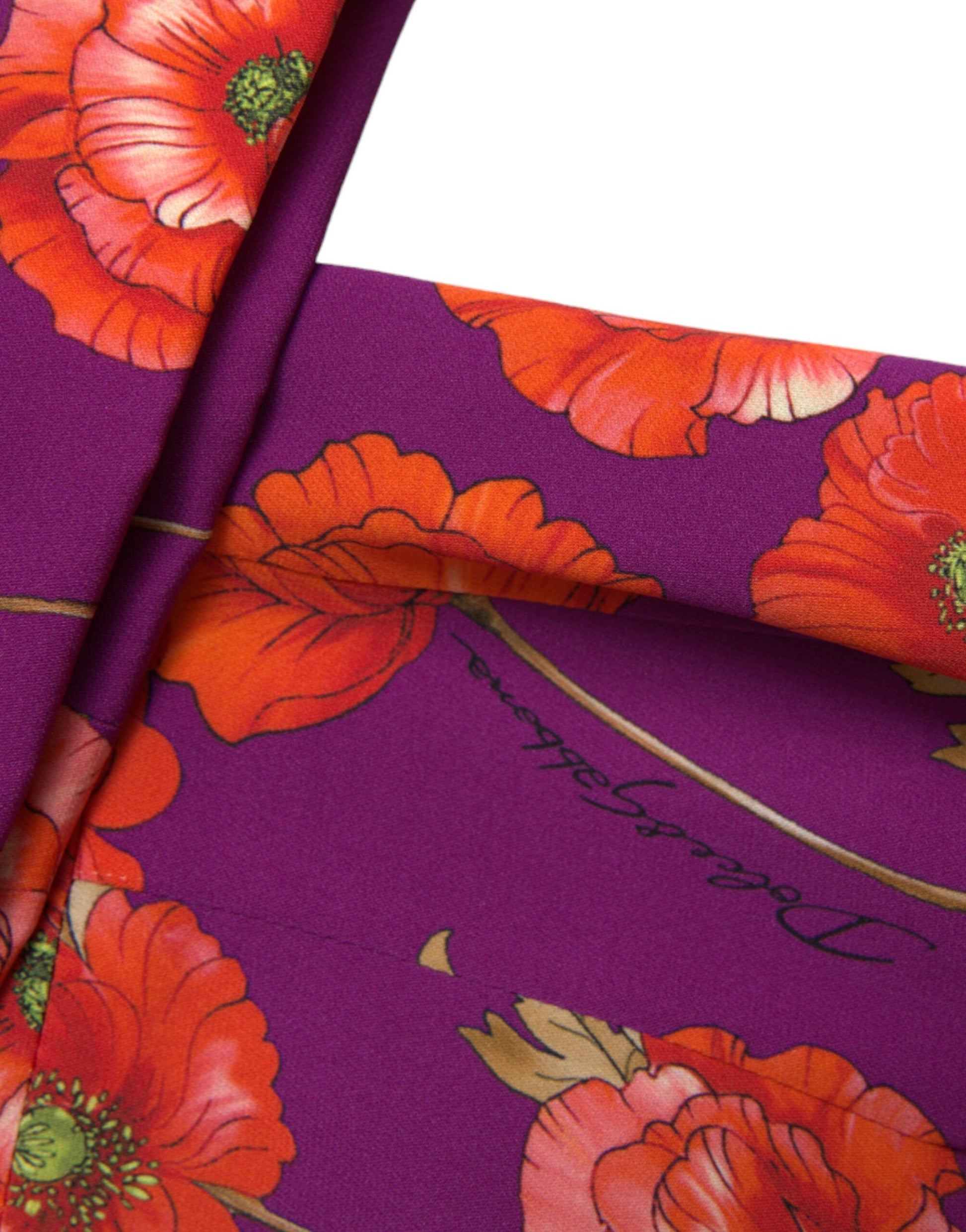 Purple dress with red flowers, gold trim, and cursive writing on the waistband