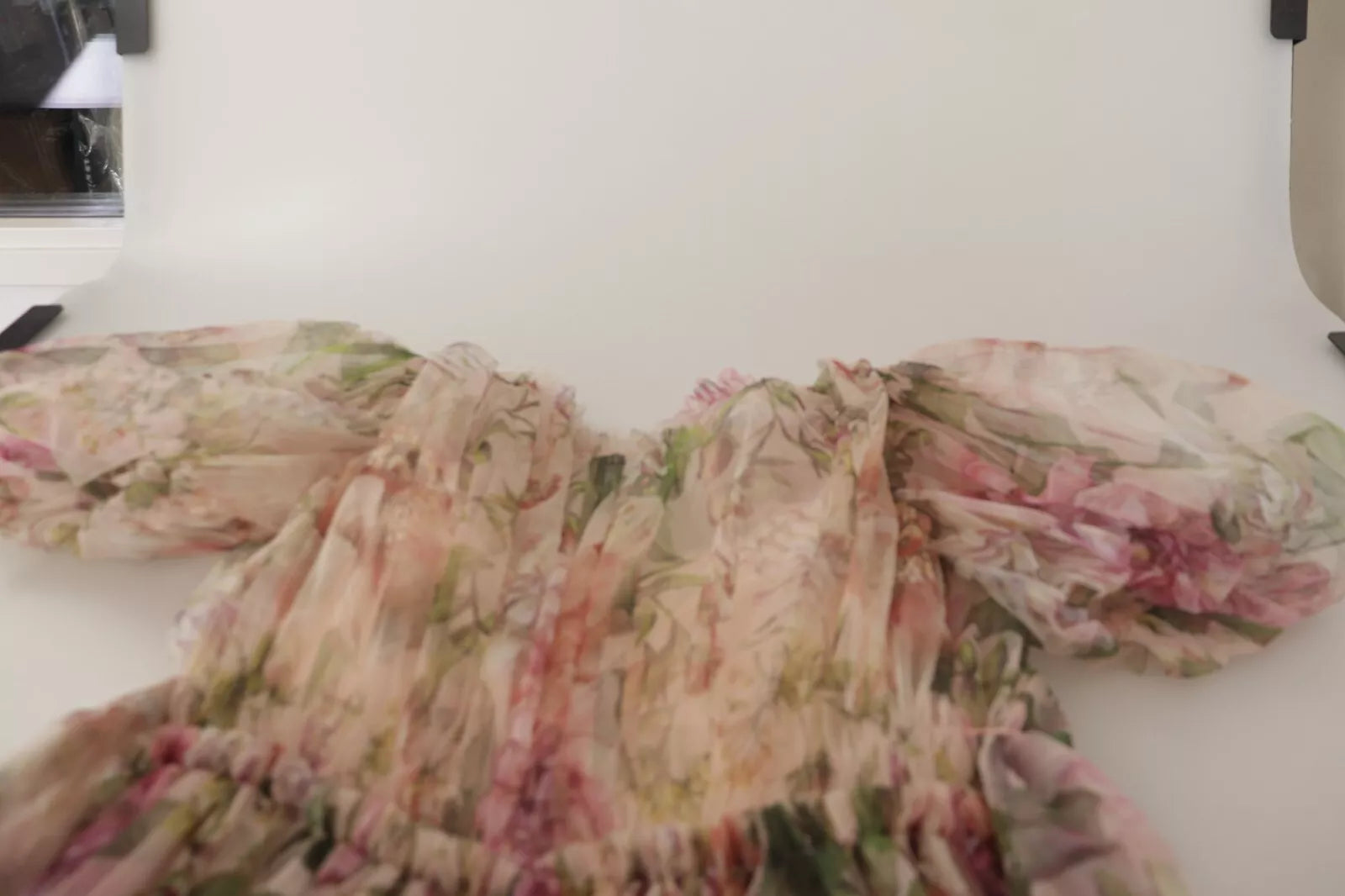 A long, multicolored floral print dress with a flowing design and sleeves