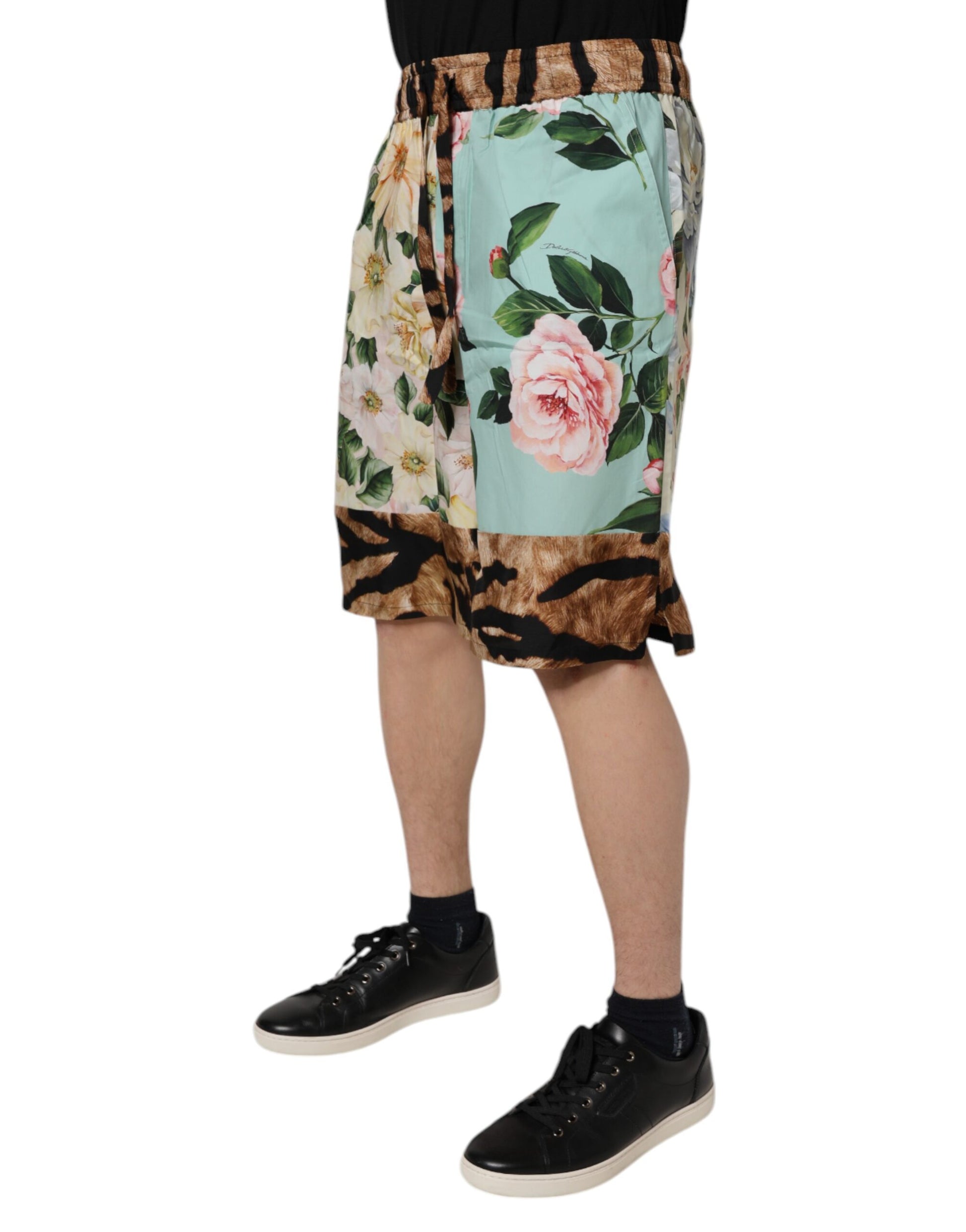 A pair of men's shorts with a floral print featuring pink and green flowers