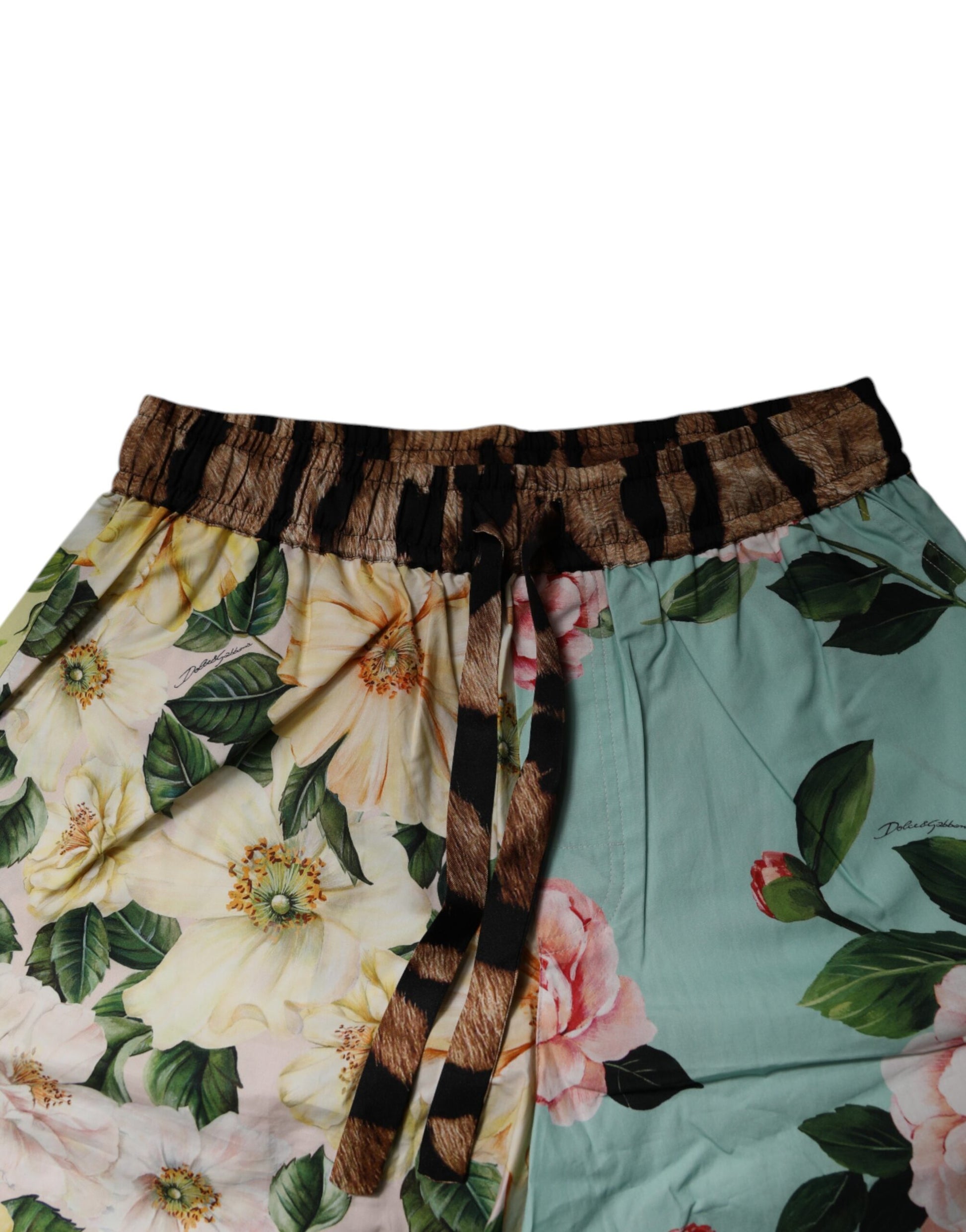 A pair of men's shorts with a floral print and a brown belt