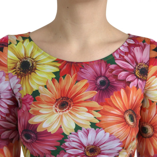 A colorful floral print sheath dress with a round neckline and short sleeves