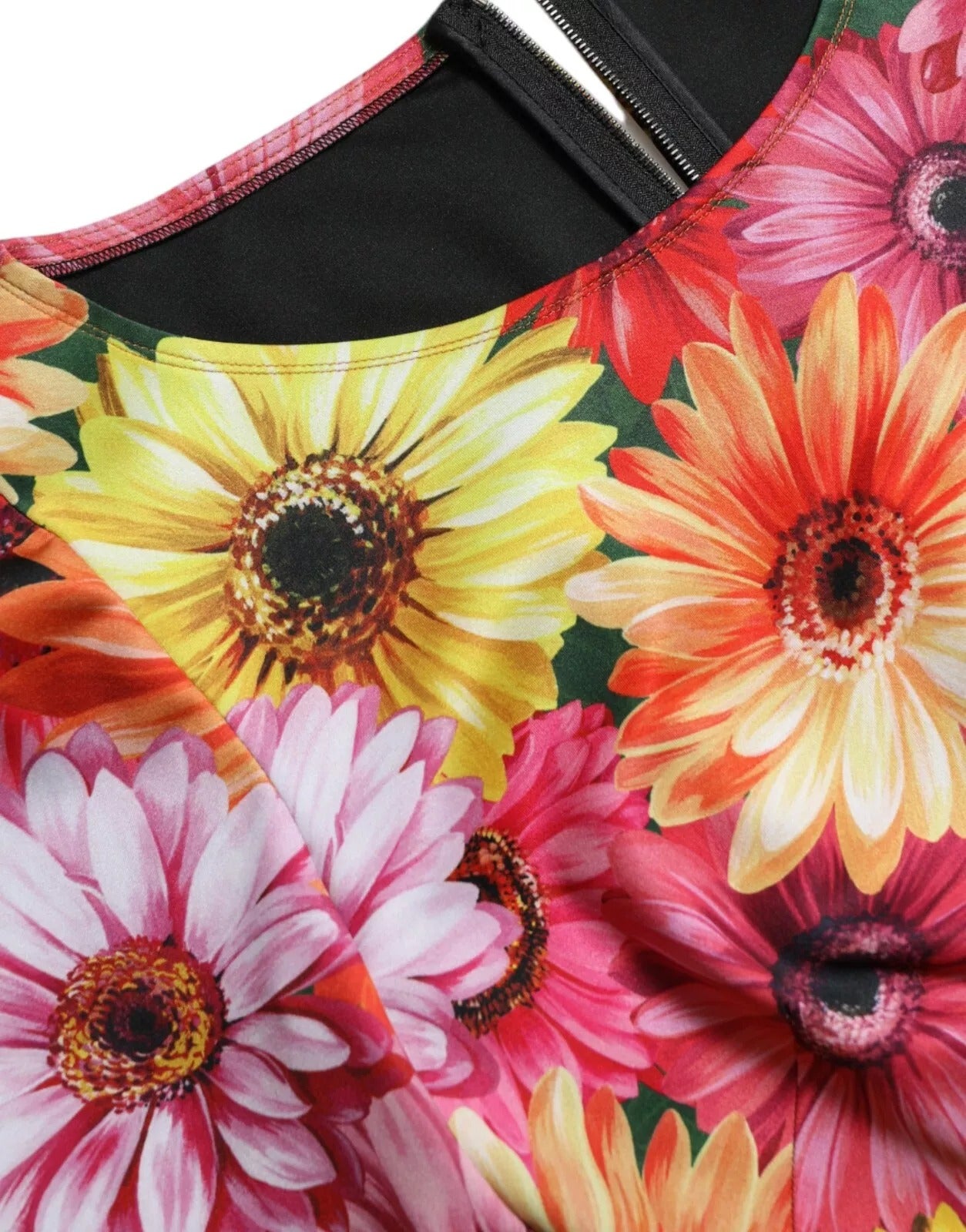 A colorful floral print dress with a sheath silhouette, featuring a vibrant mix of flowers on a black background