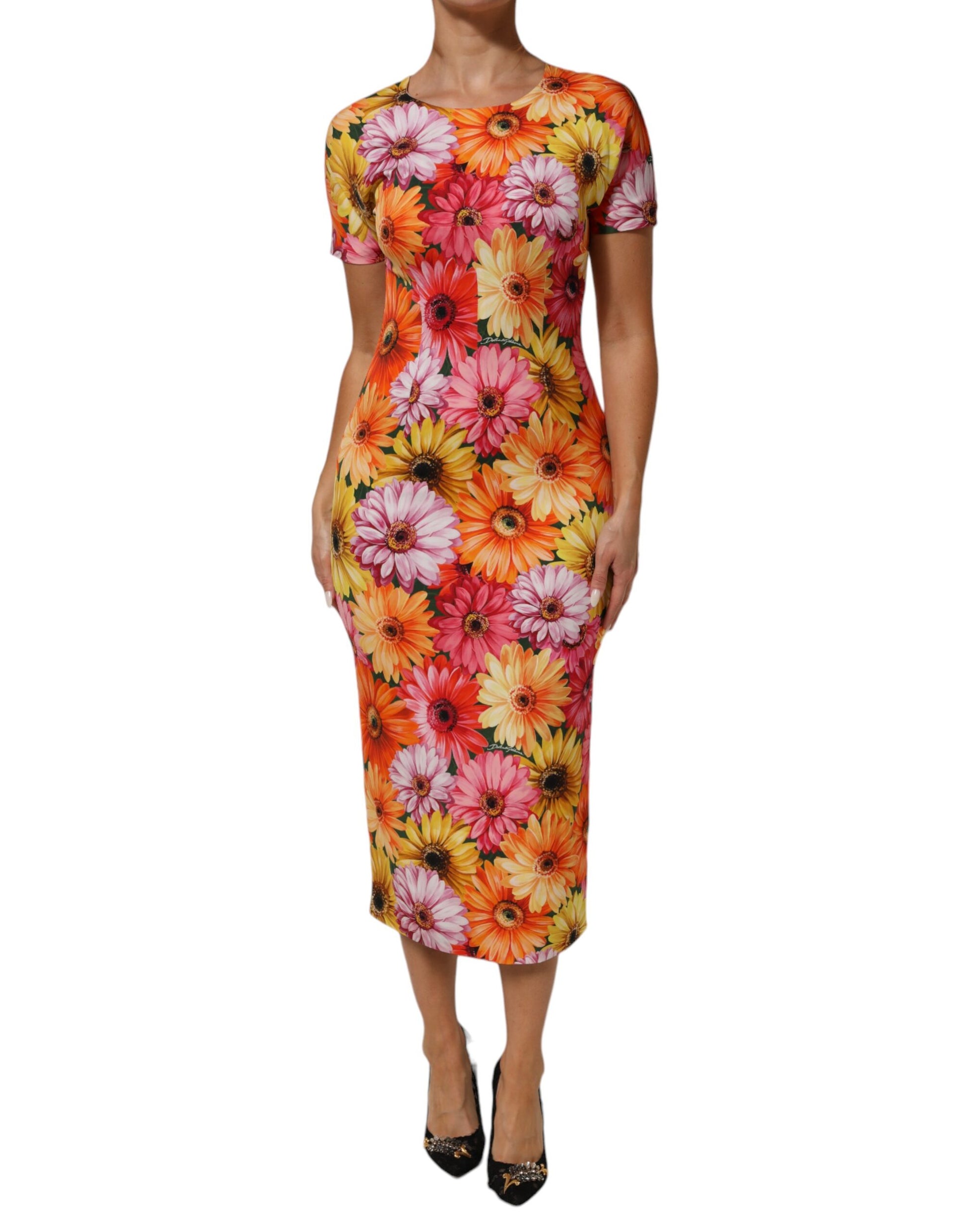 A midi dress with a floral print in shades of pink, orange and yellow