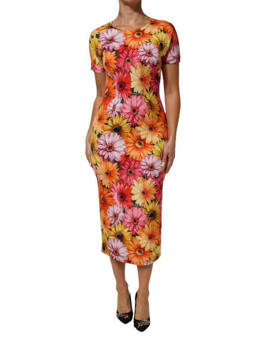 A midi dress with a floral print in shades of pink, orange and yellow