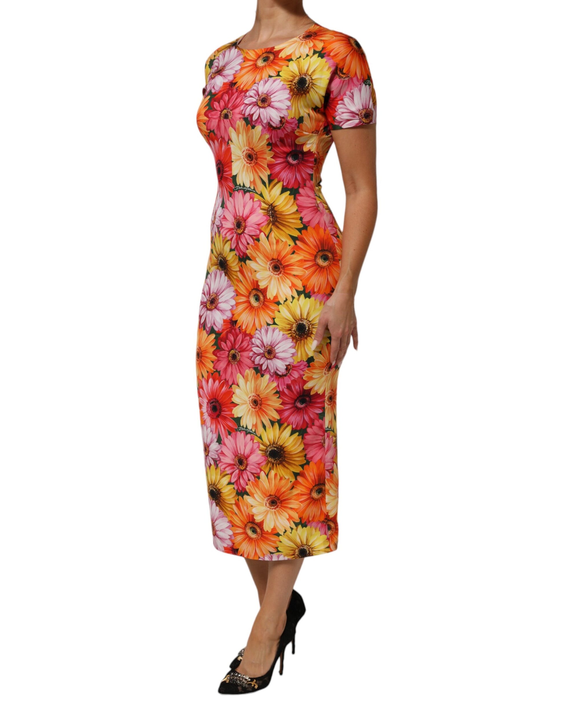 A midi dress with a floral print in shades of orange, yellow and green