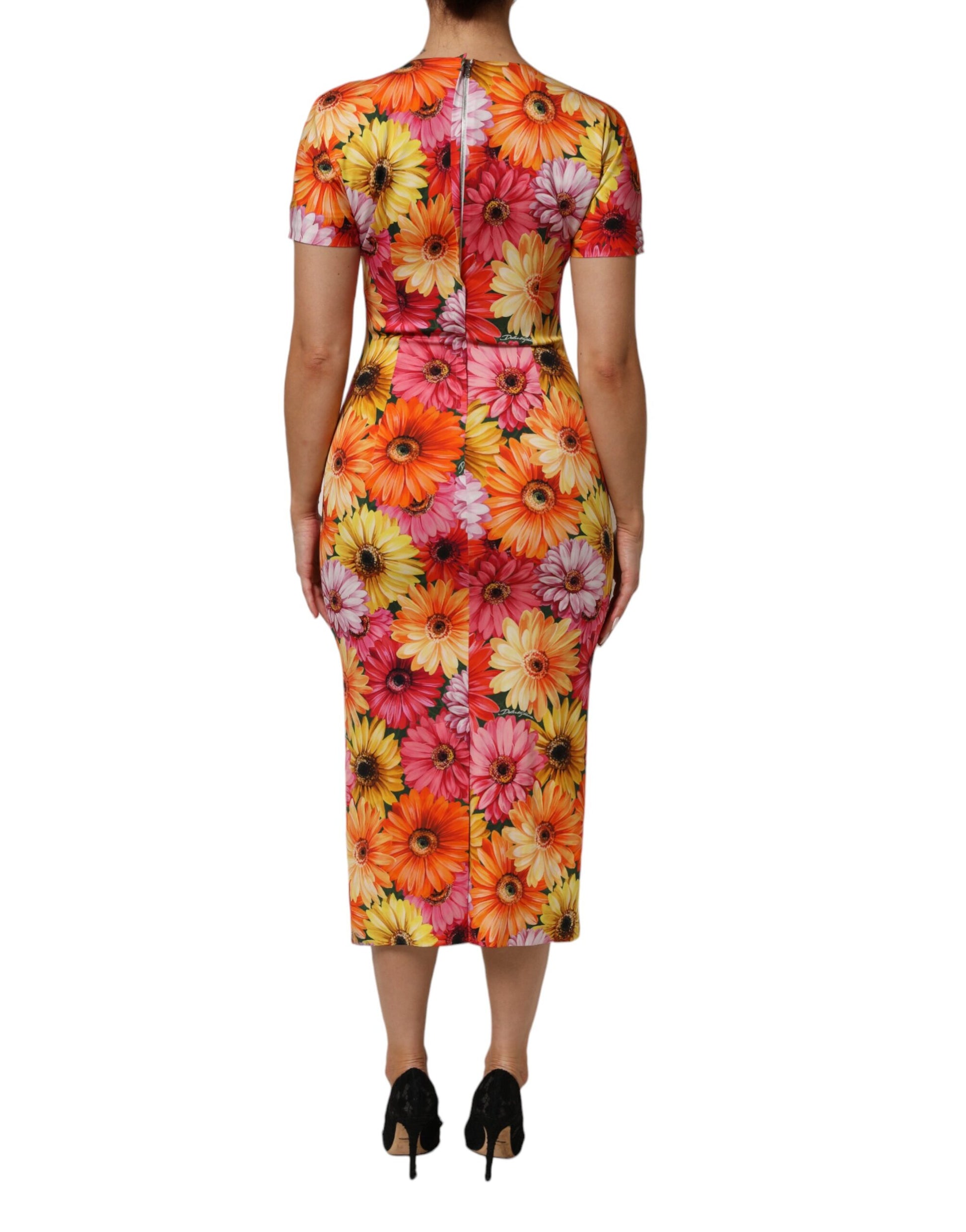 A midi dress with a floral print in shades of pink, yellow and green