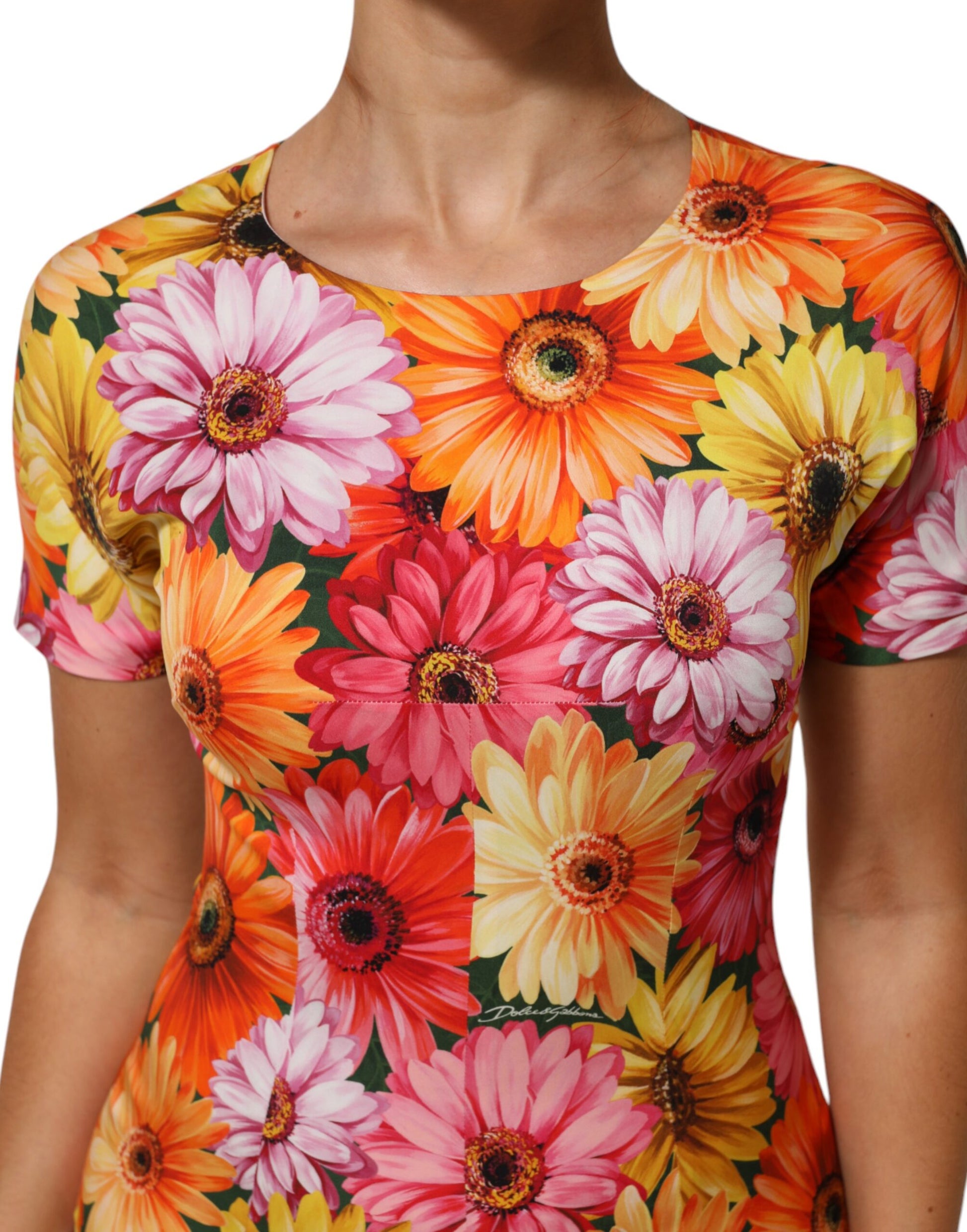 A woman's dress with a floral print of pink, yellow and orange flowers